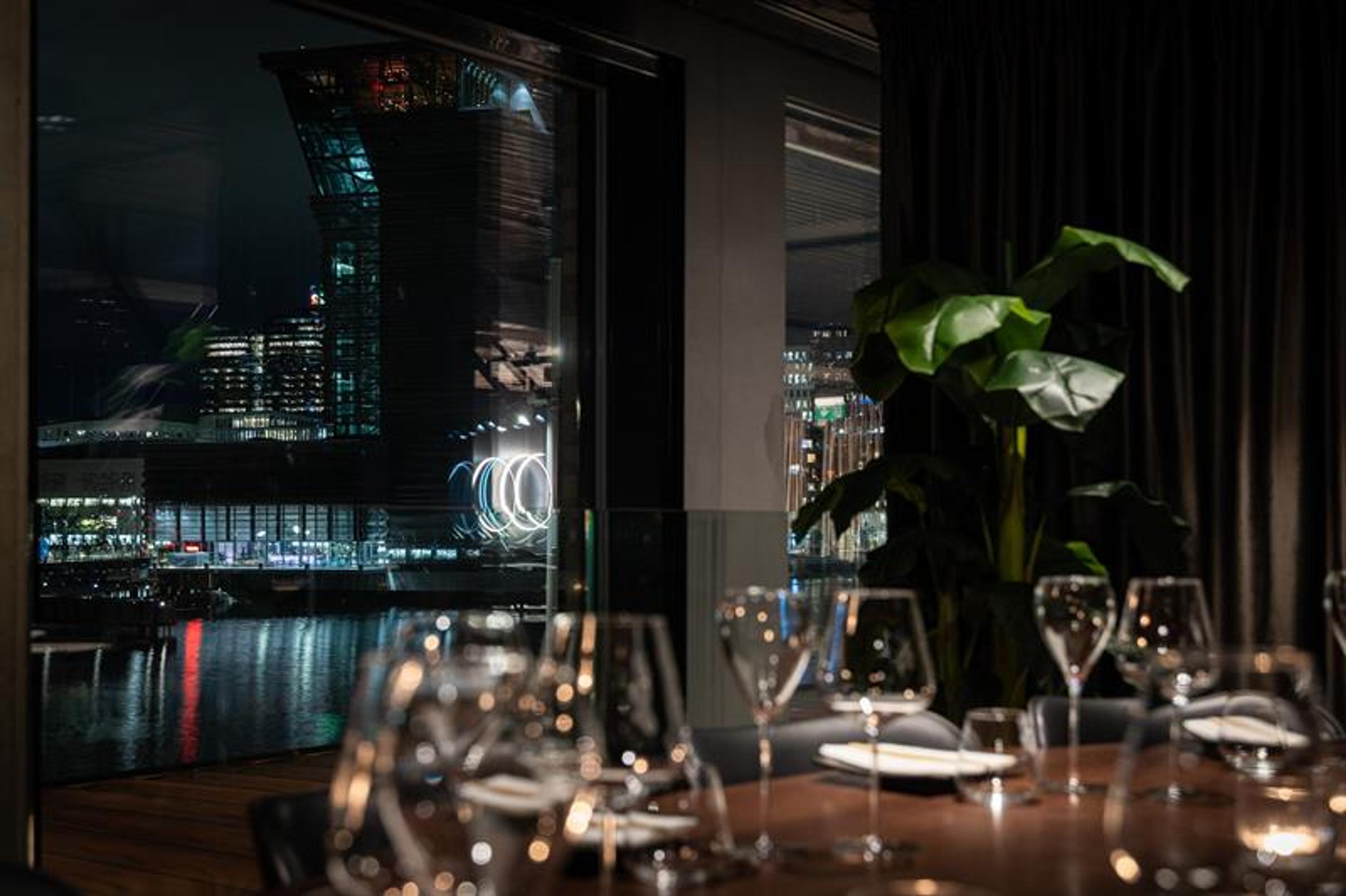 A table set for dining with a view of MUNCH in the background