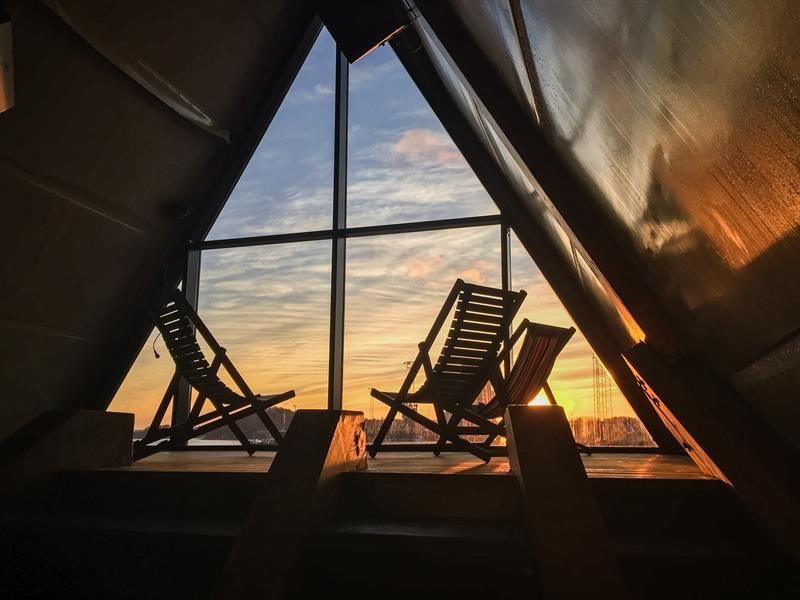 Sunbeds with a view of Oslo at sunset inside one of the saunas 