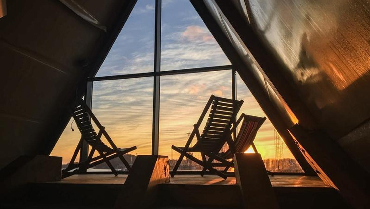 Sunbeds with a view of Oslo at sunset inside one of the saunas