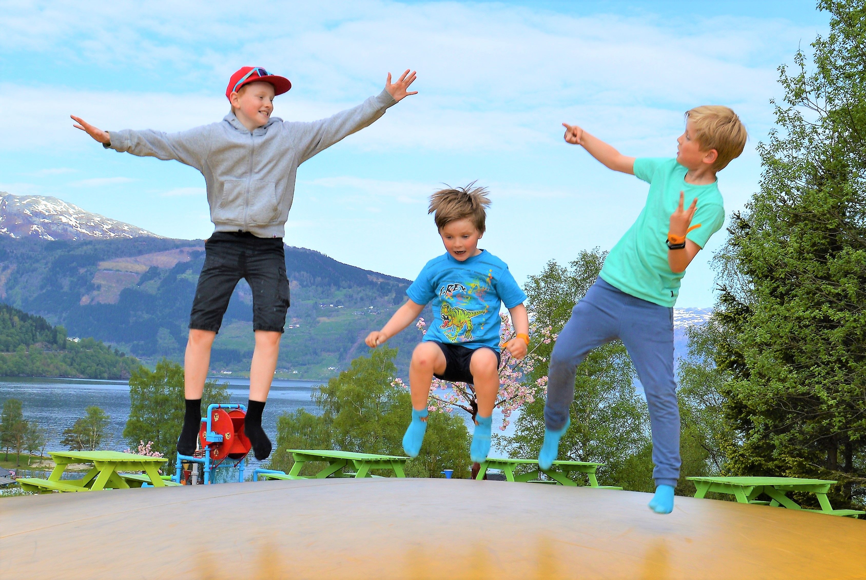 Kids jumping and having fun on the trampoline with fjord views at Mikkelparken