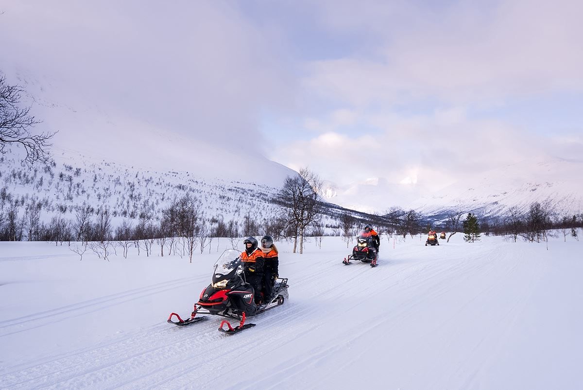 Snow scooter trip through the forest