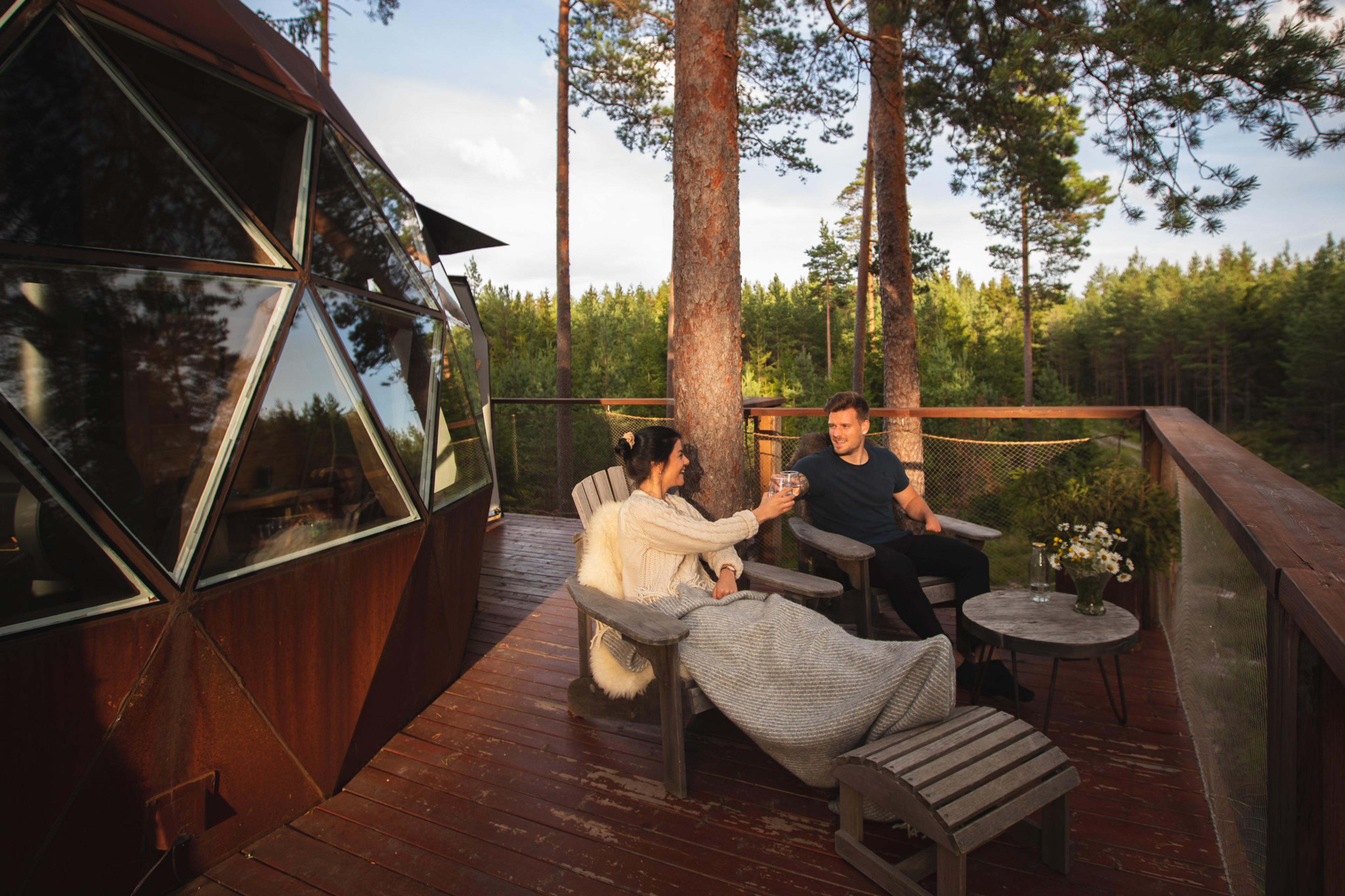 A couple sitting outside the cabin