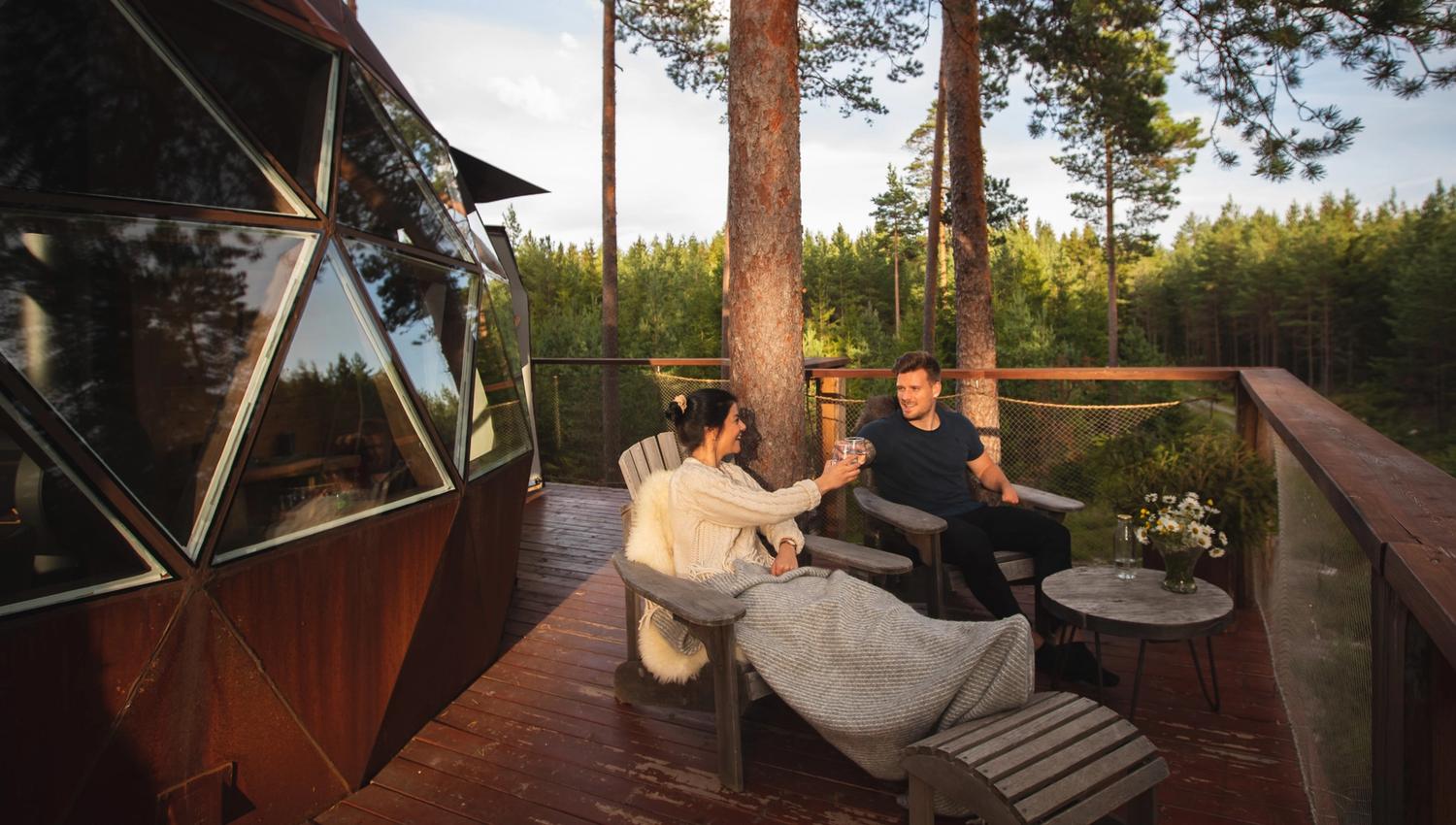 A couple sitting outside the cabin