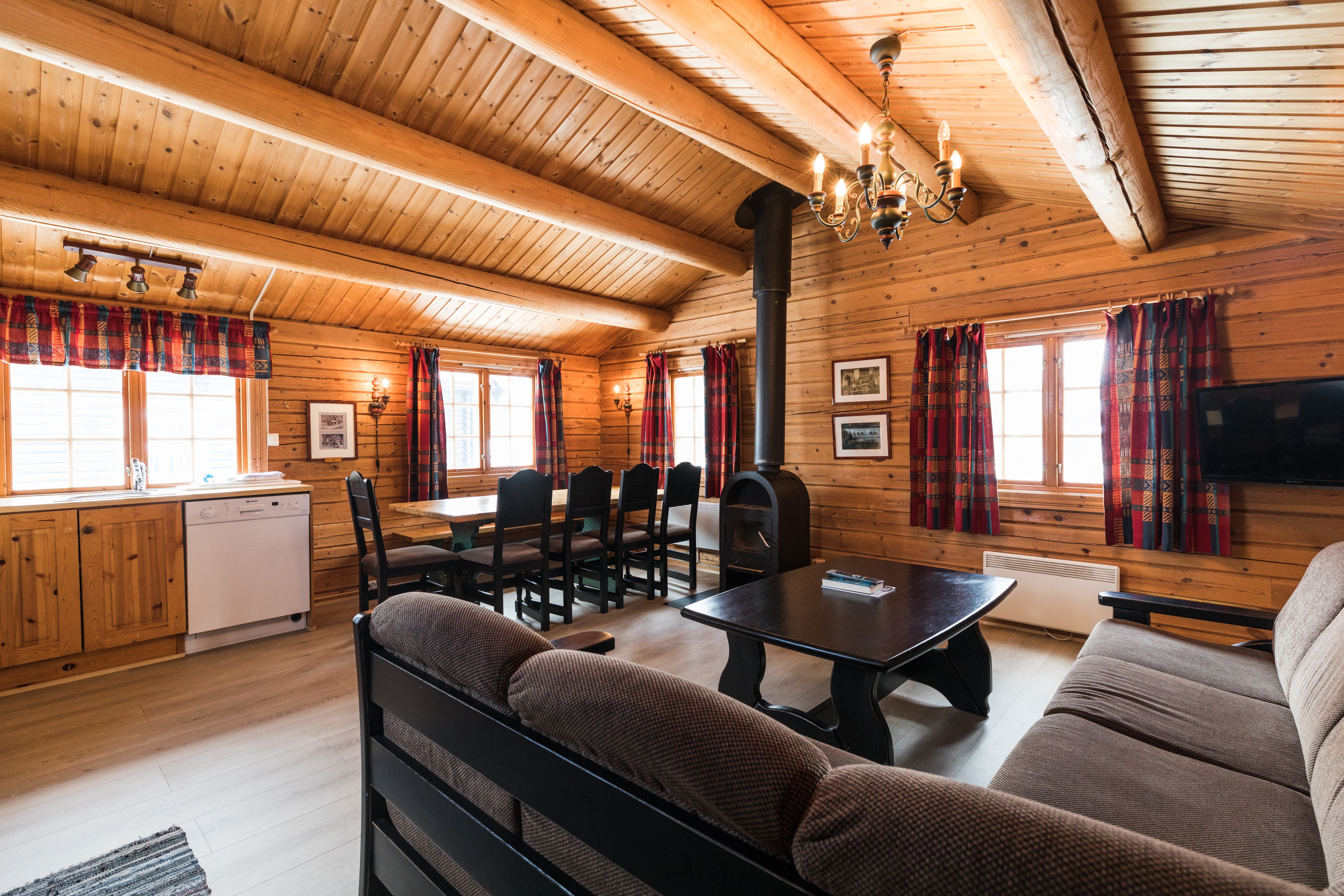 Shared lounge with dining table , fire place sofa and kitchen furniture