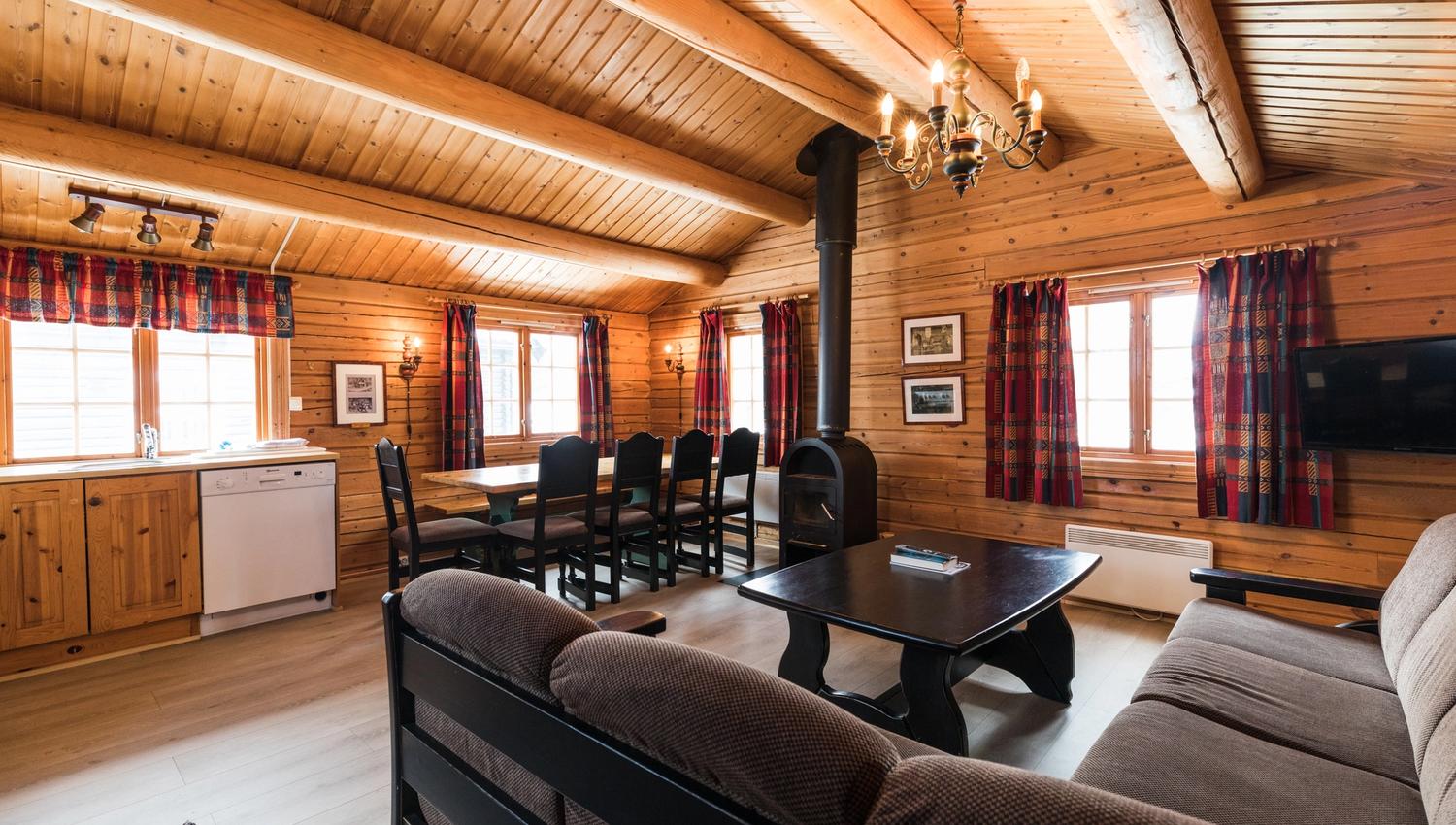 Shared lounge with dining table , fire place sofa and kitchen furniture