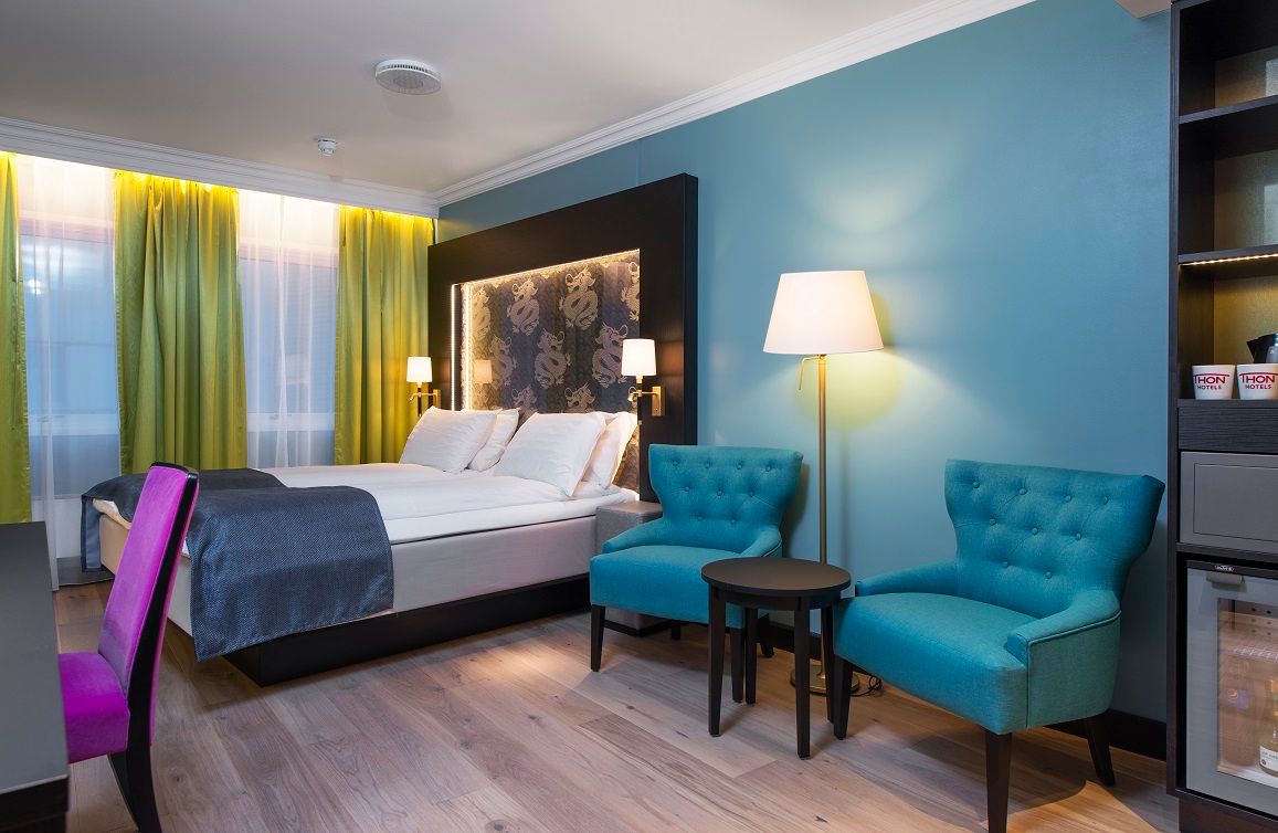 double room with wardrobe, desk and armchairs 