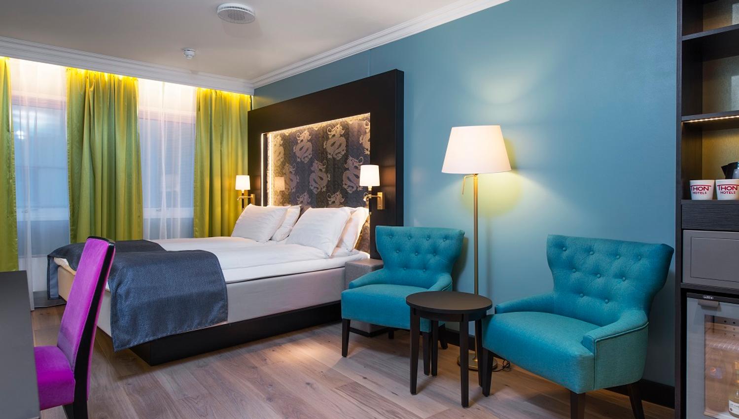 double room with wardrobe, desk and armchairs