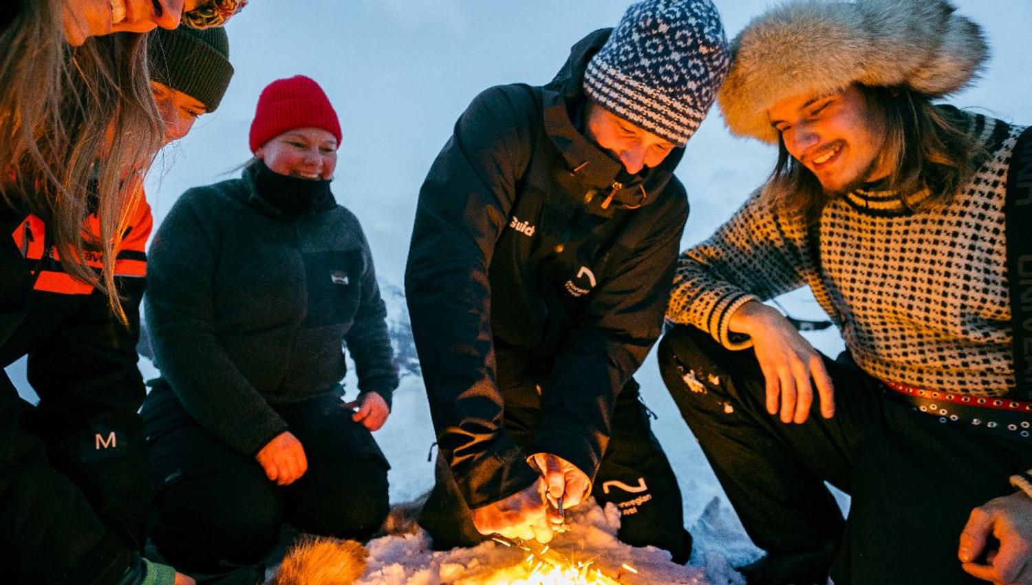 Guests sit around the campfire