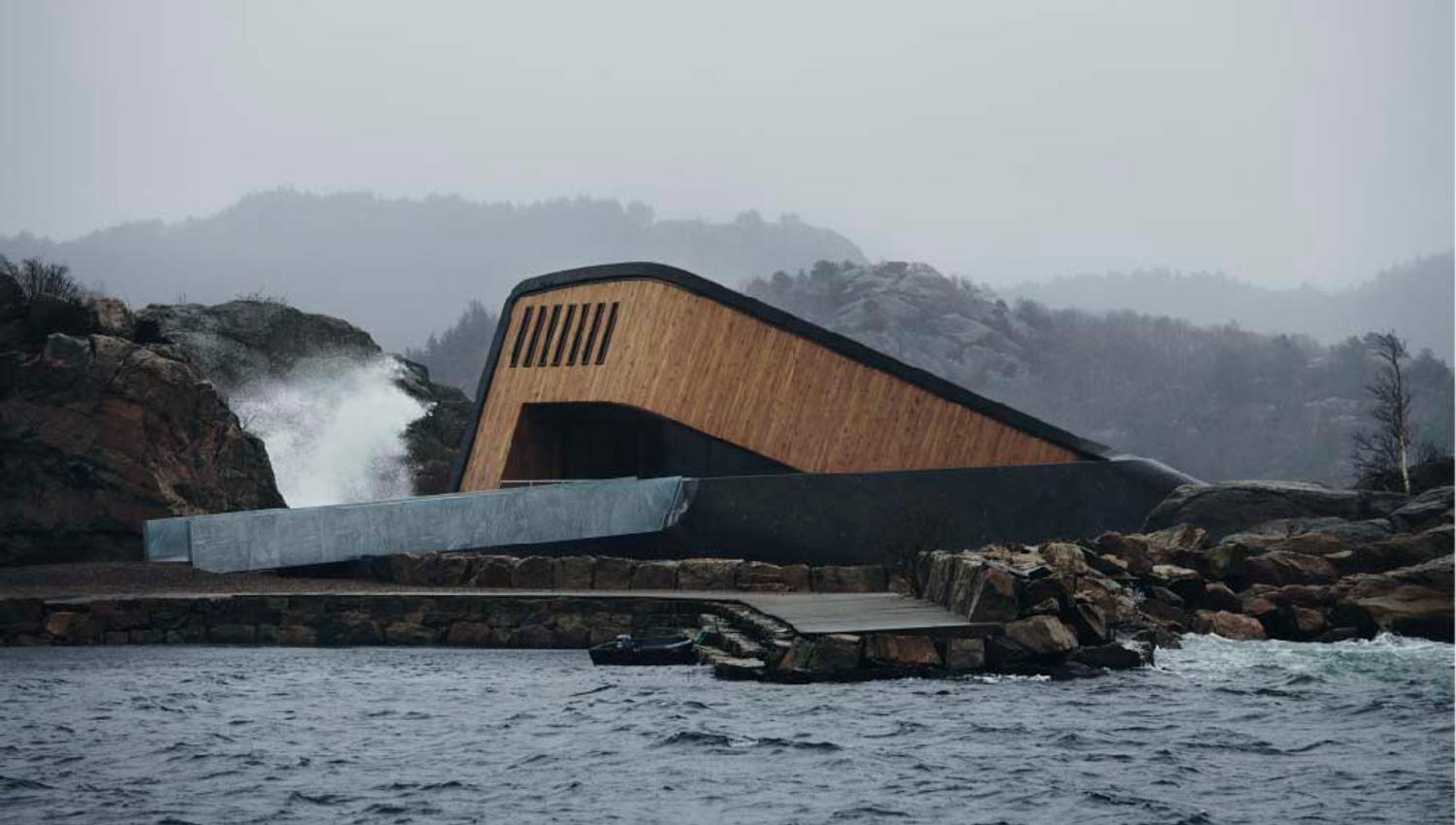 The facade of the restaurant, a brown building with black details. Foggy and gray weather.