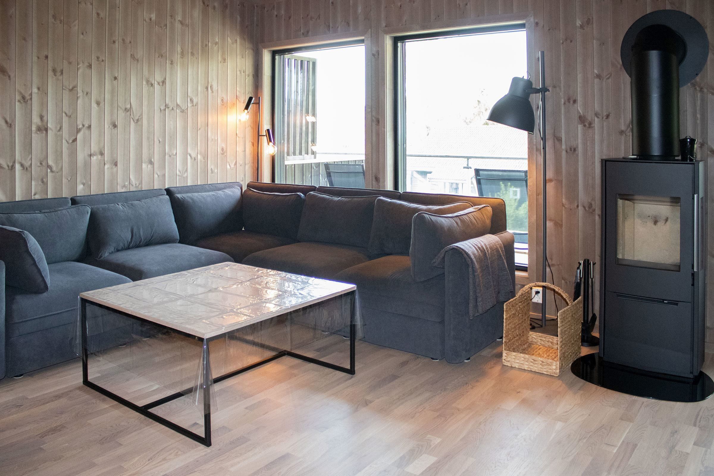 A living room with a sofa and a glass table.