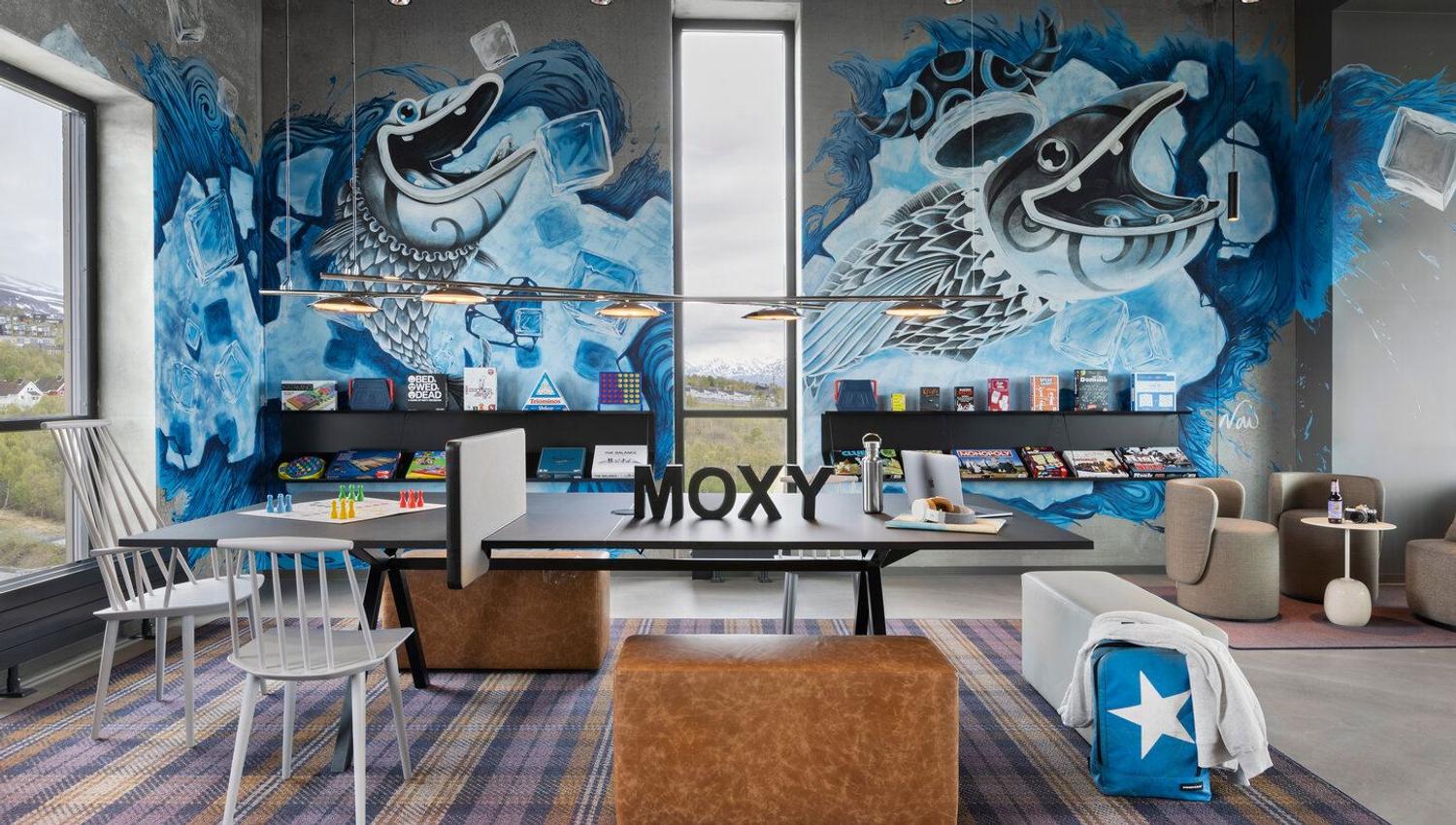 Work area in the common areas in the top floor, with graffiti art of fish on the walls.