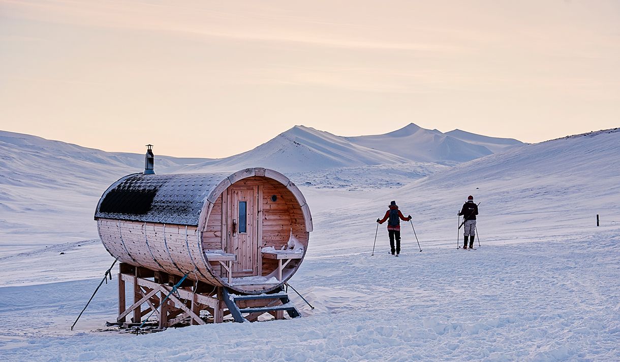 Two skiers next to the sauna at Juva Cabin