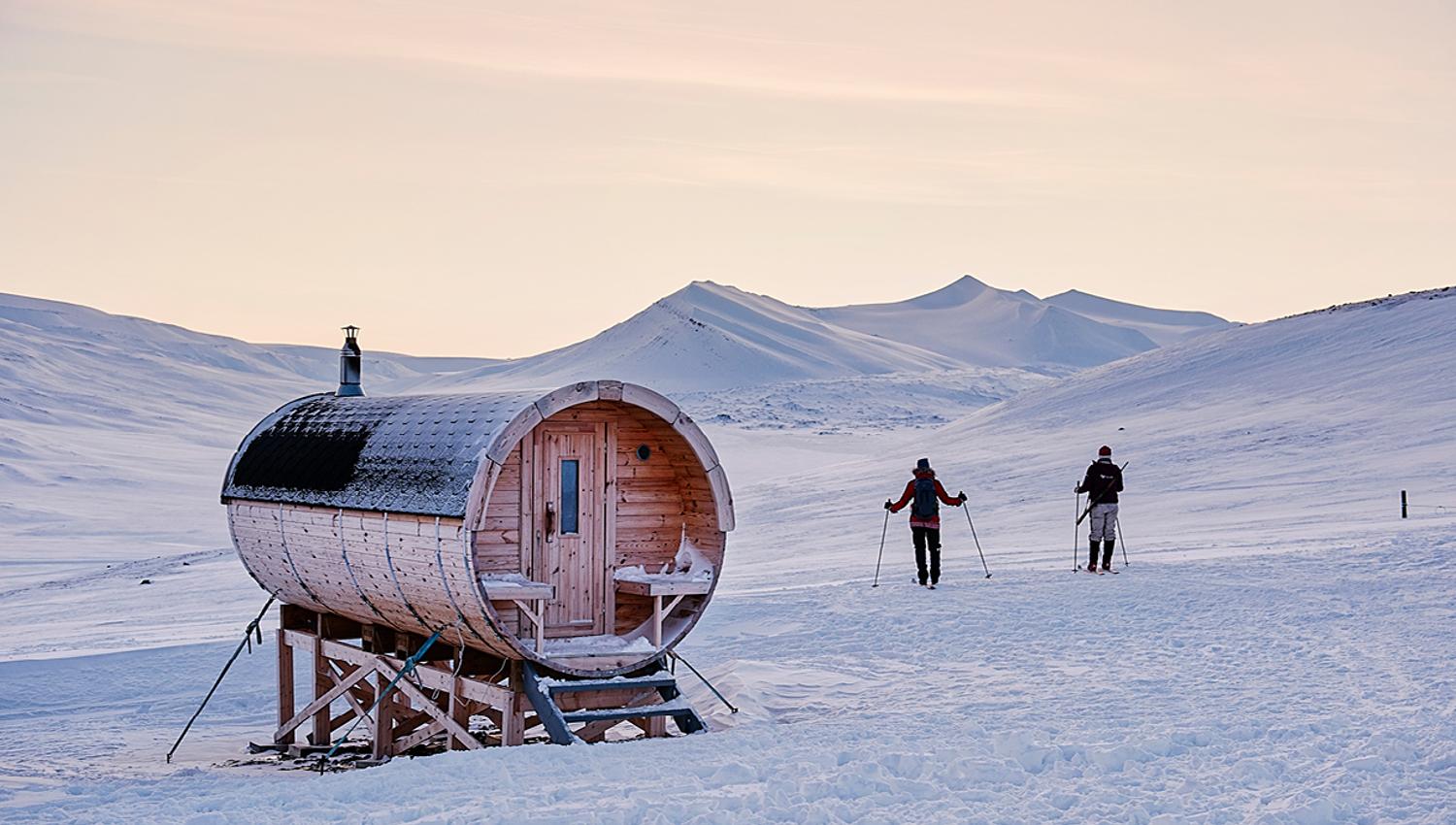 Two skiers next to the sauna at Juva Cabin