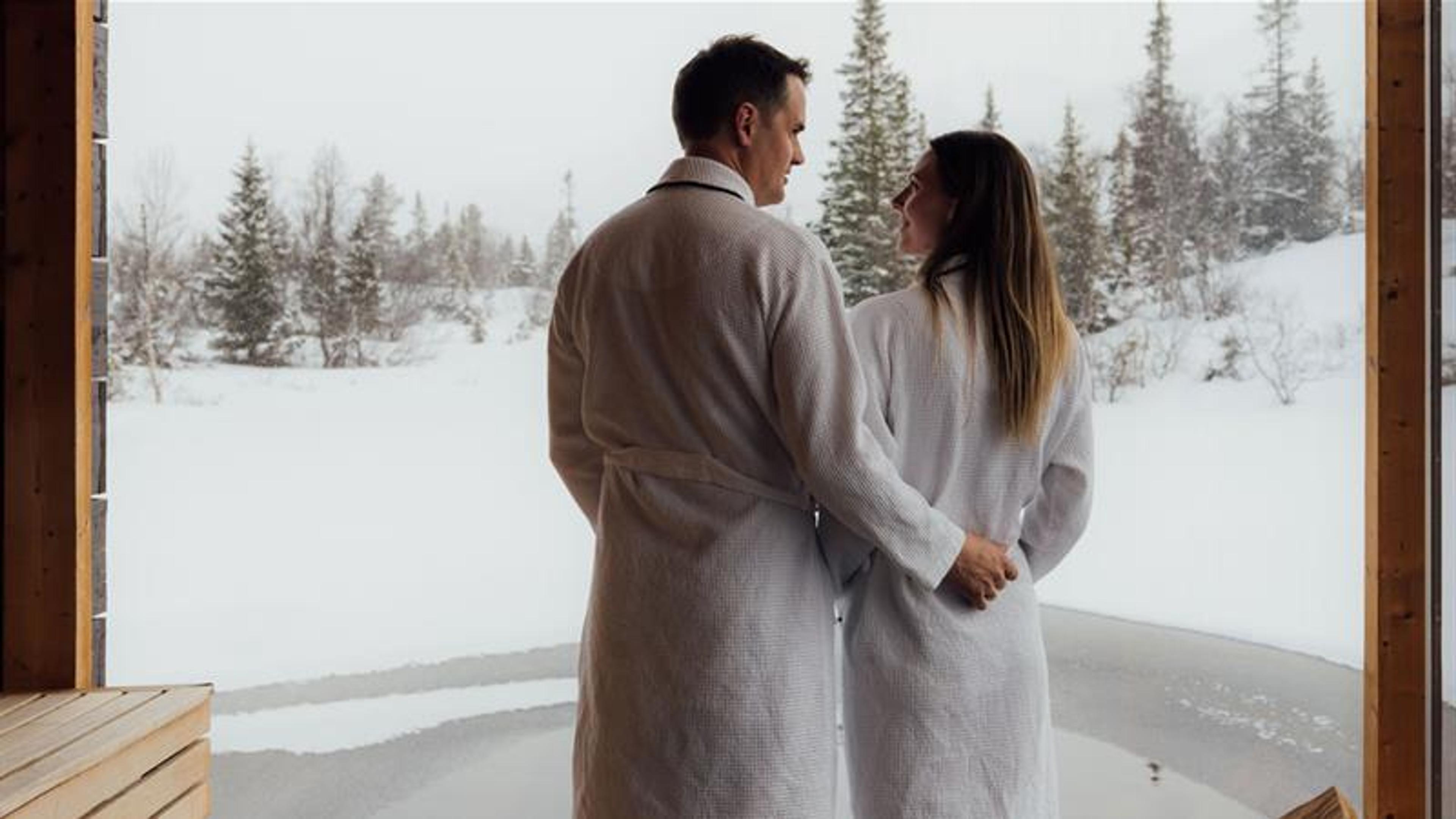 couple on a floating sauna in winter