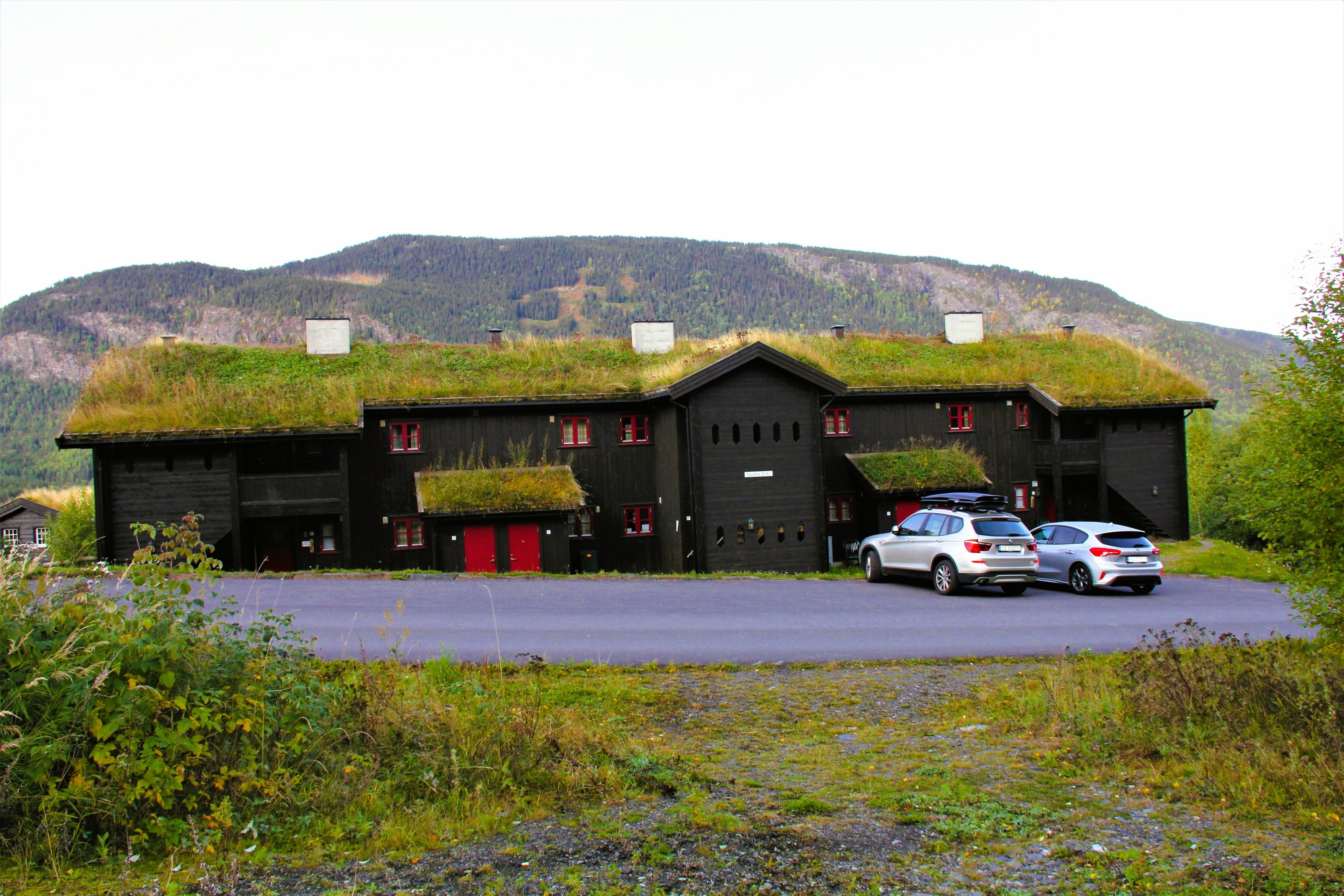 Cars parked cars in front of a building.