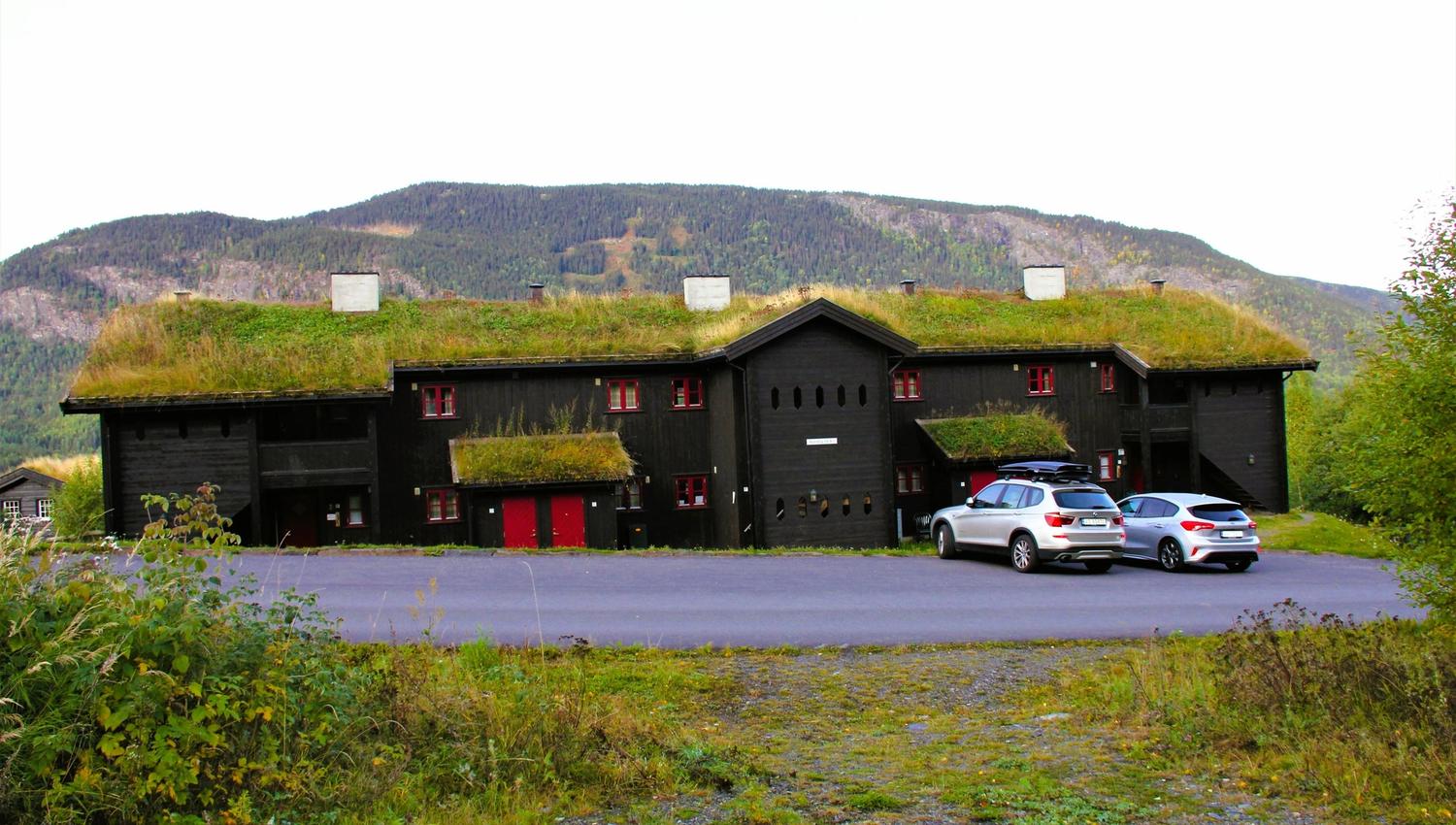 Cars parked cars in front of a building.