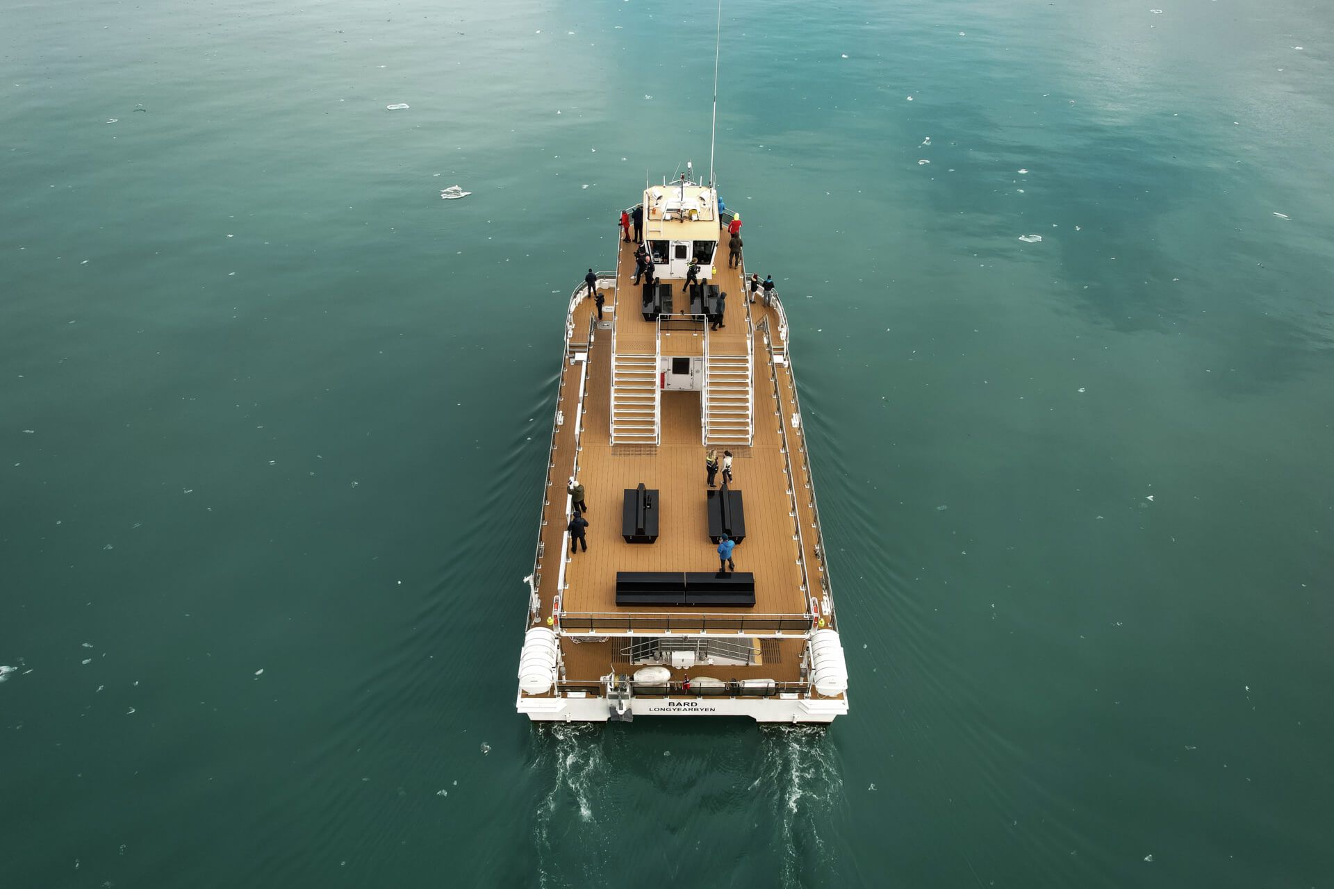 A boat (MS Bard) seen from above as it sails on a fjord