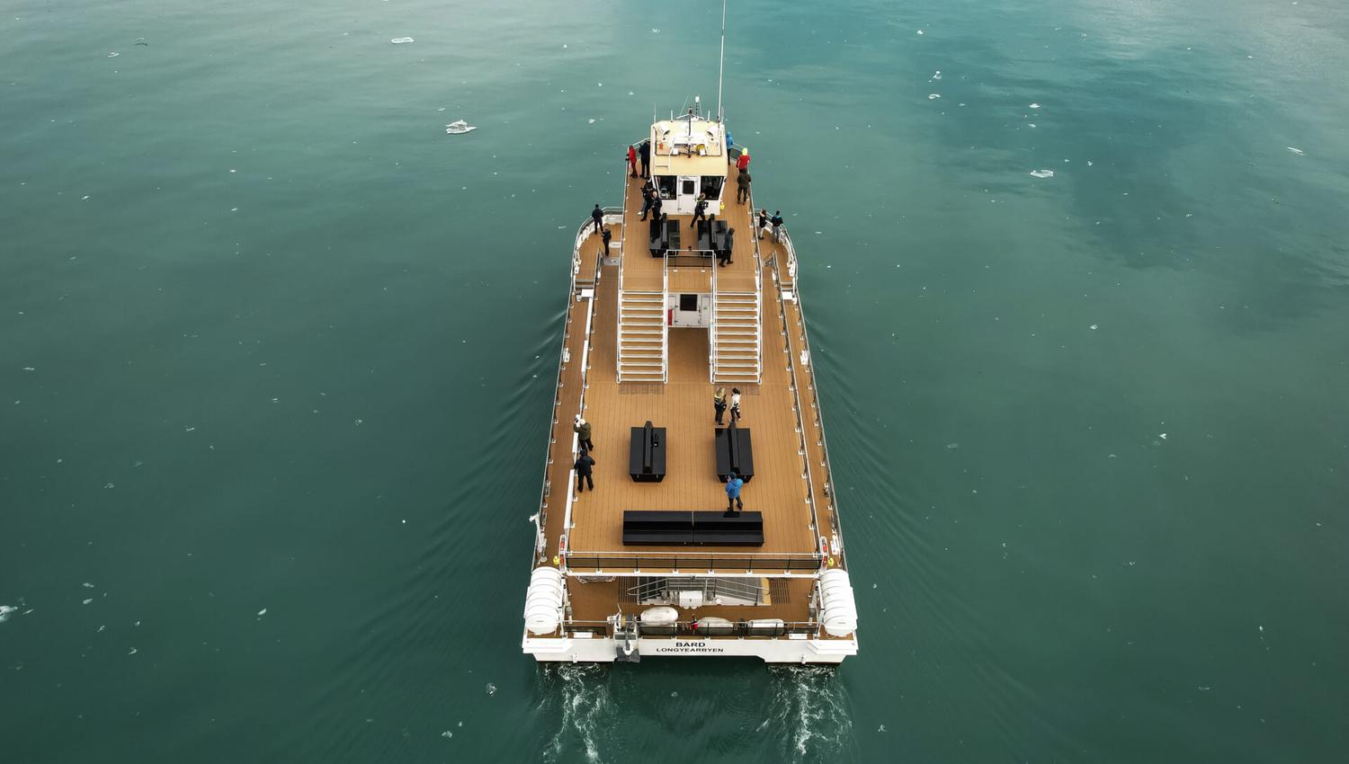 A boat (MS Bard) seen from above as it sails on a fjord