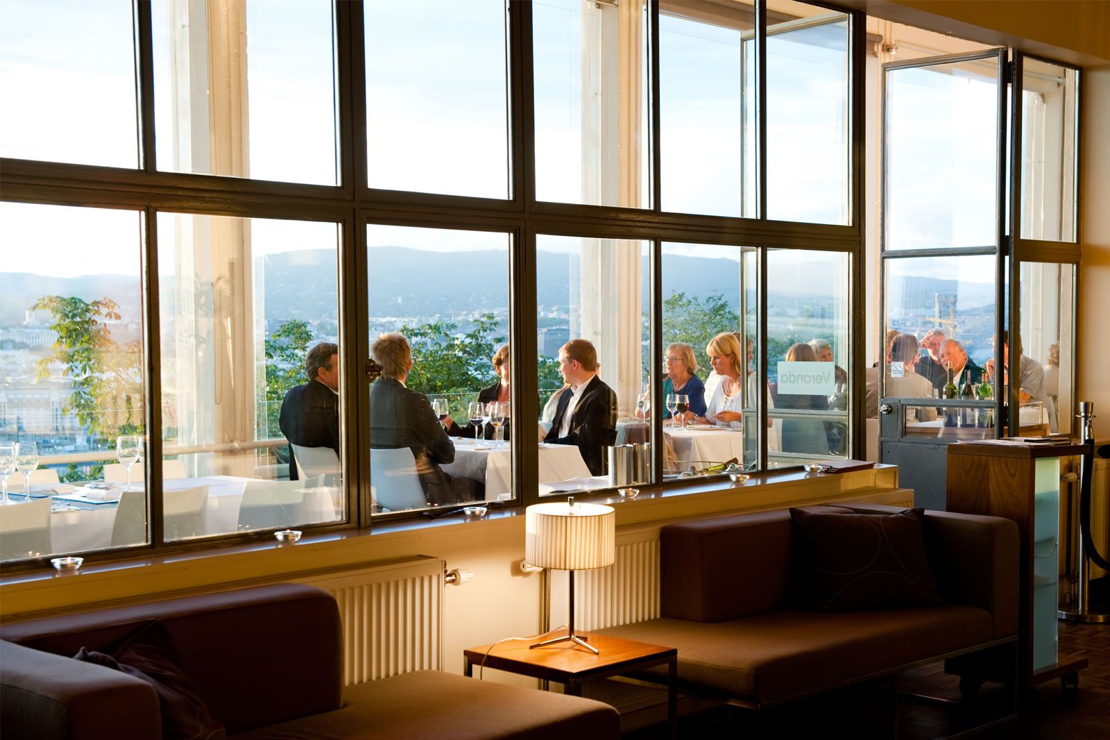 Sofa group inside with windows facing the city.
