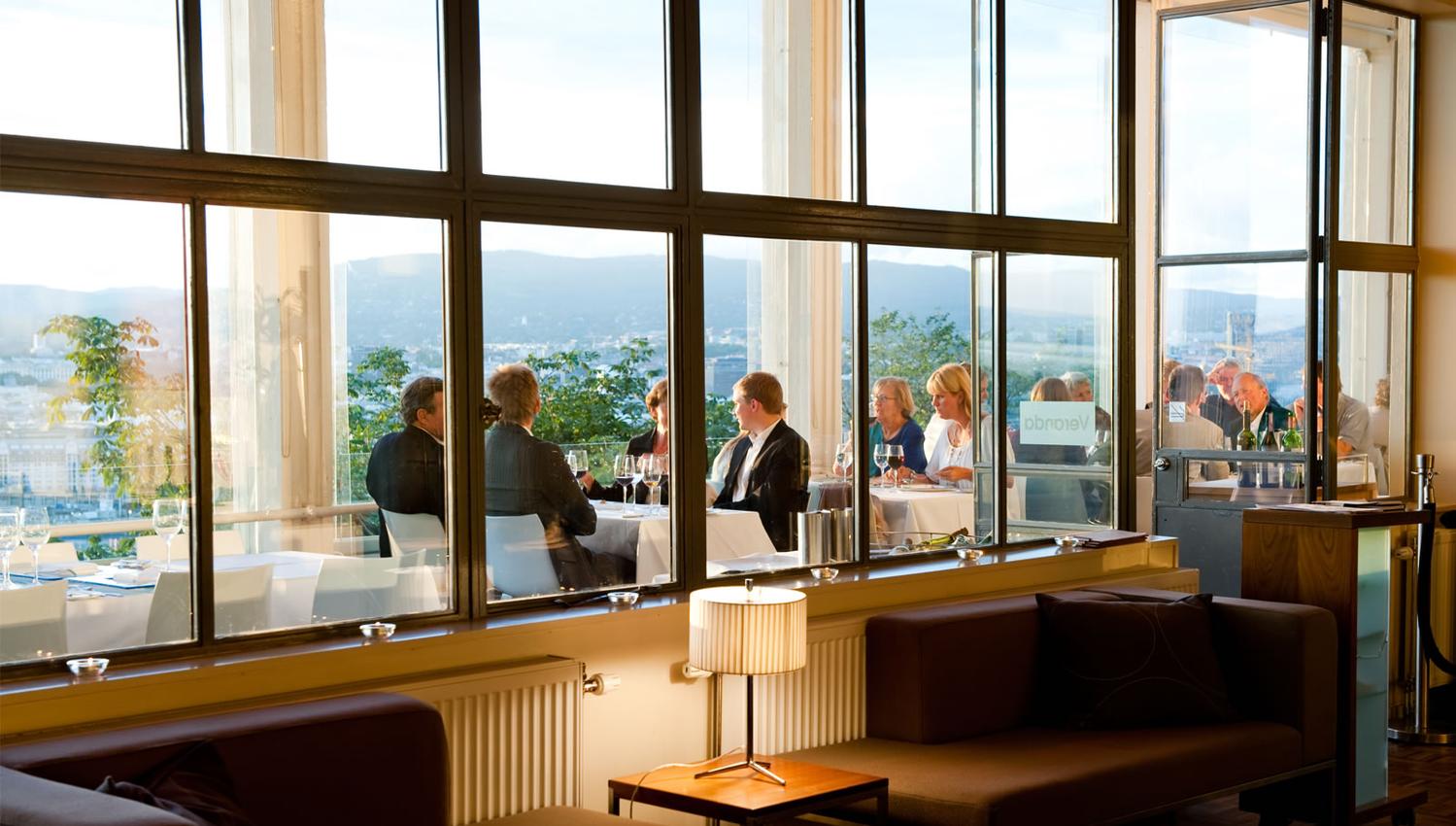 Sofa group inside with windows facing the city.