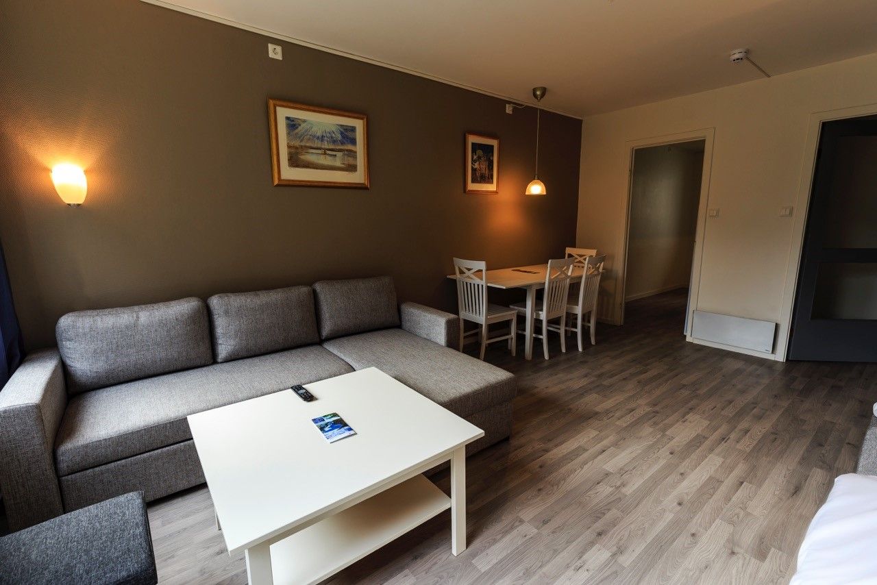 Cozy living area with sofa and dining table at Trolltunga Guesthouse – perfect for relaxing after a mountain hike.