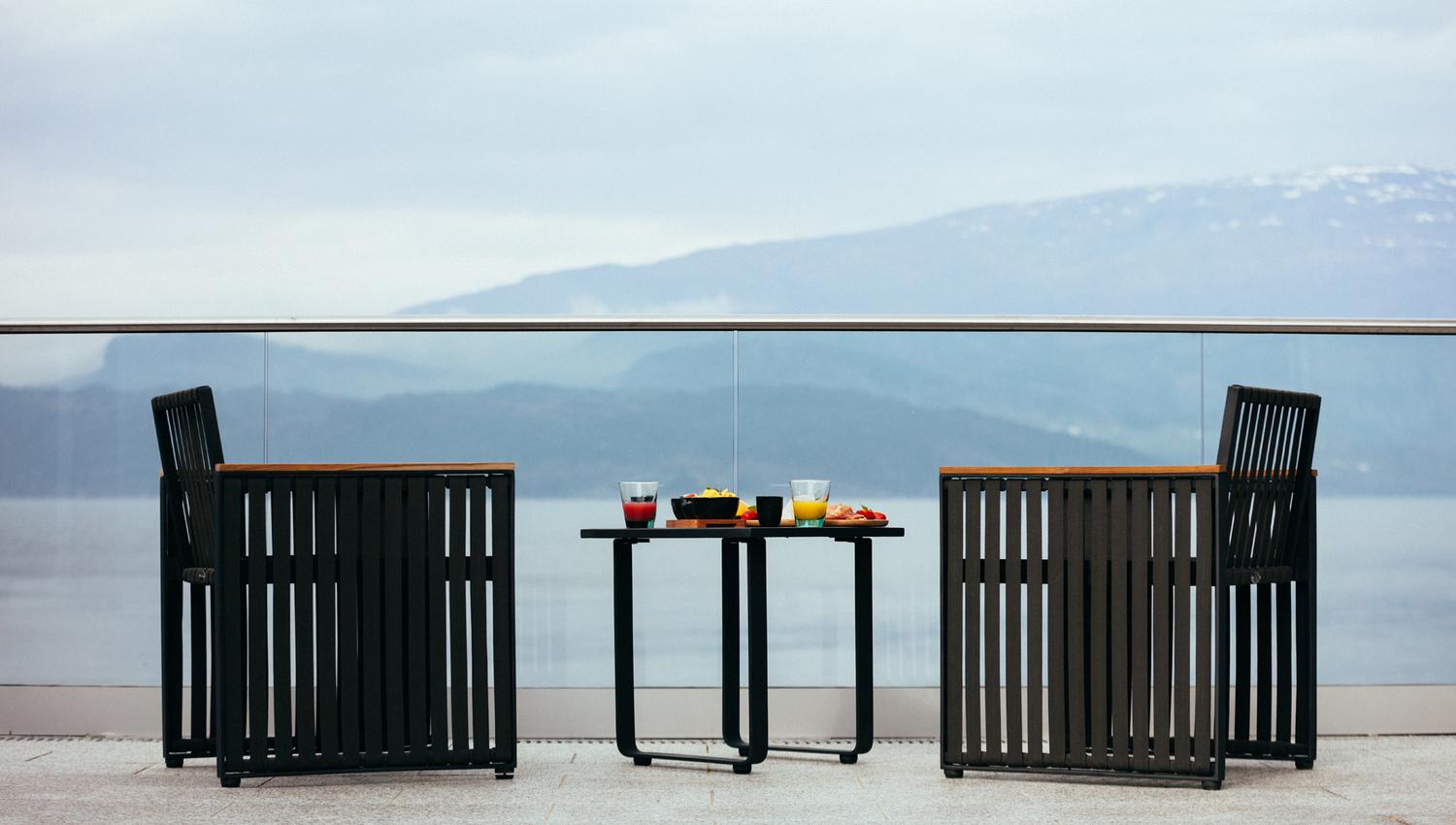 Comfortable outdoor seating on the terrace with a stunning fjord view.