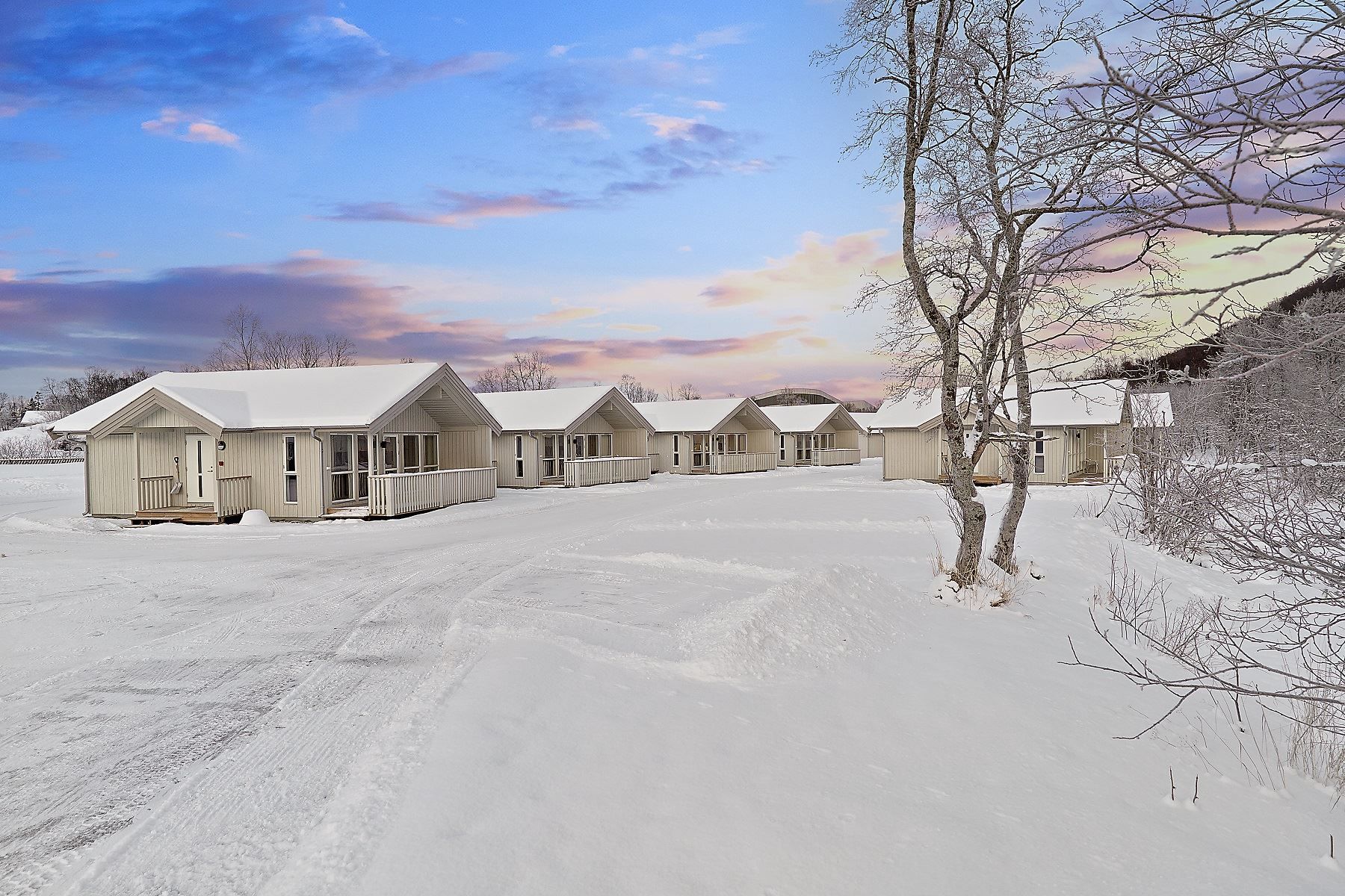 Row of small cabins in a snowy landscape