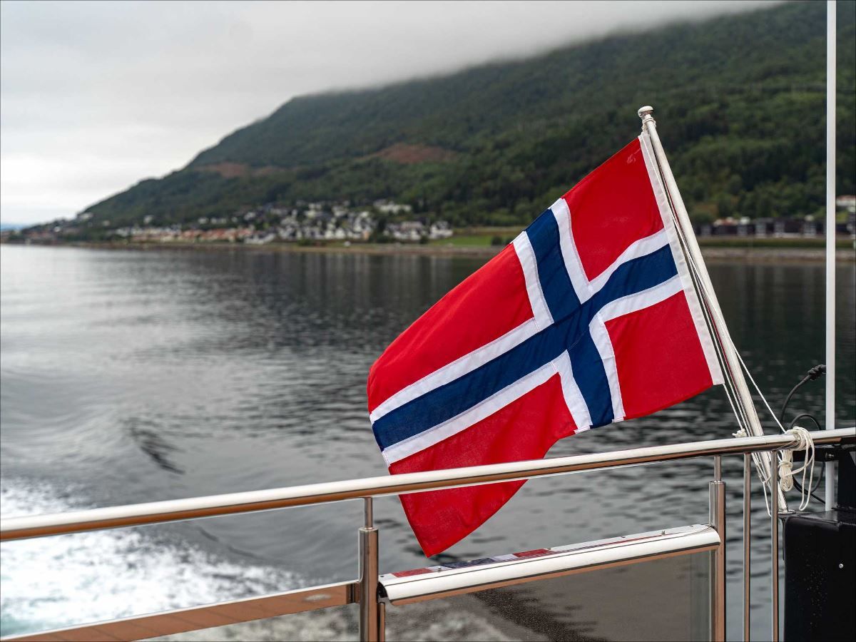The Norwegian flag sways behind the boat