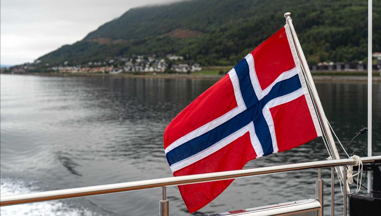 The Norwegian flag sways behind the boat