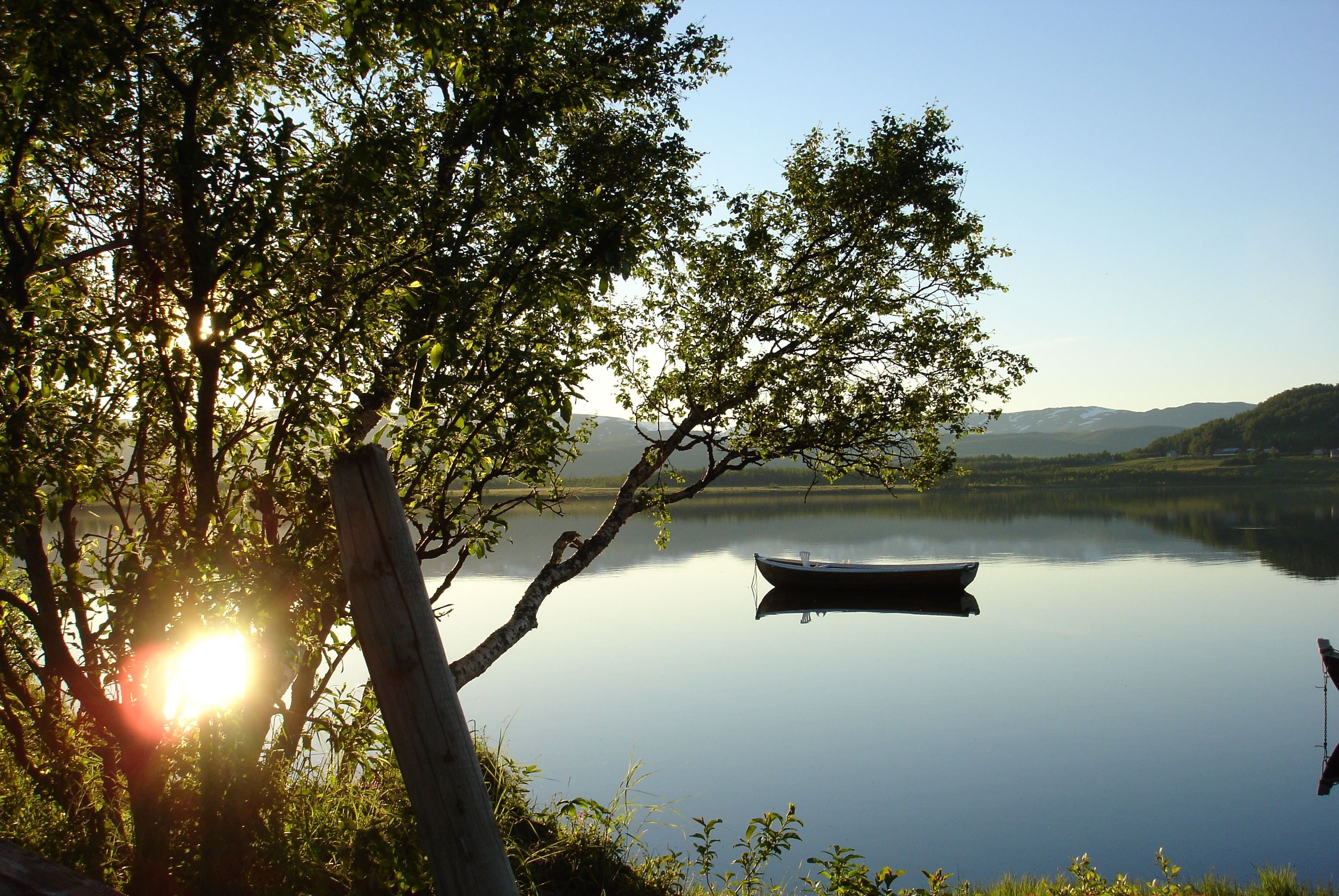 sunshine on a lake with a boat