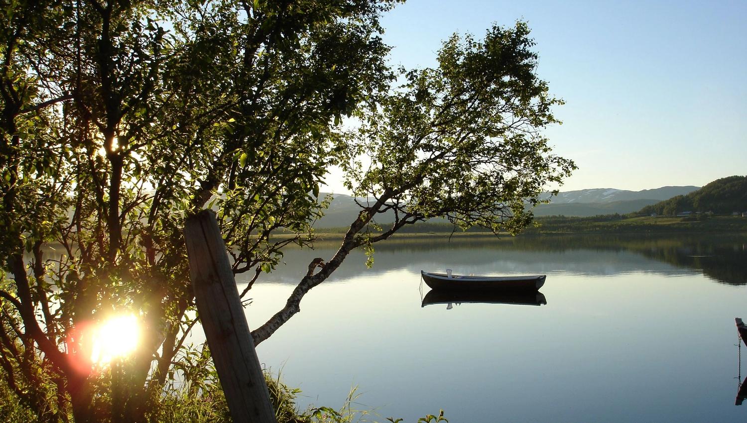 sunshine on a lake with a boat