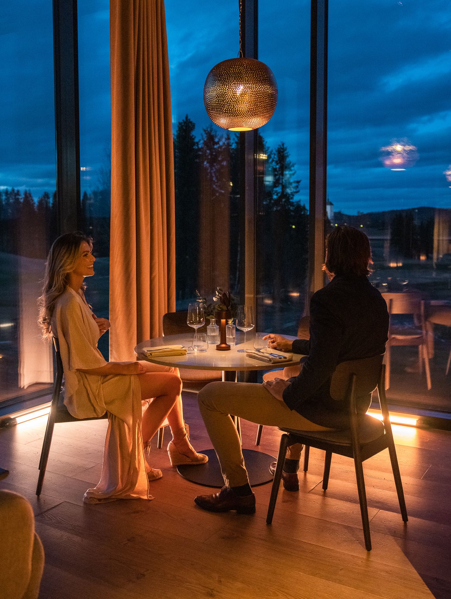 Young couple waiting for dinner in a restaurant with noice view 