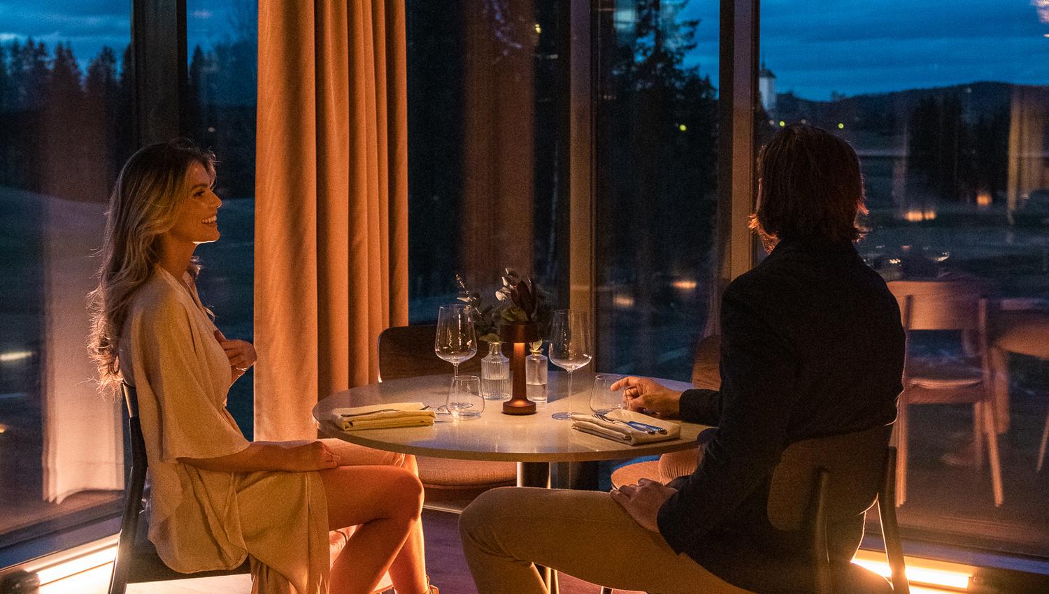 Young couple waiting for dinner in a restaurant with noice view