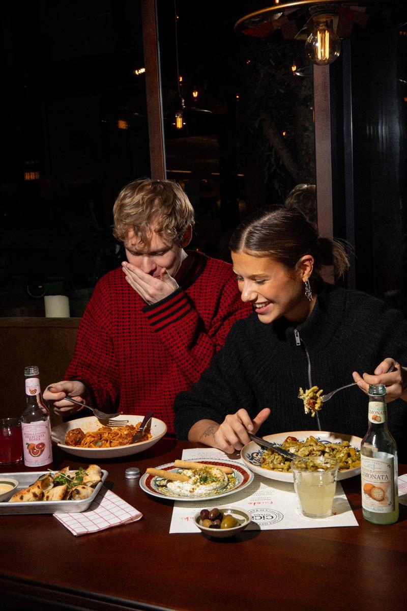 Two people eating pasta