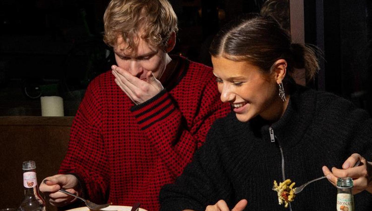 Two people eating pasta