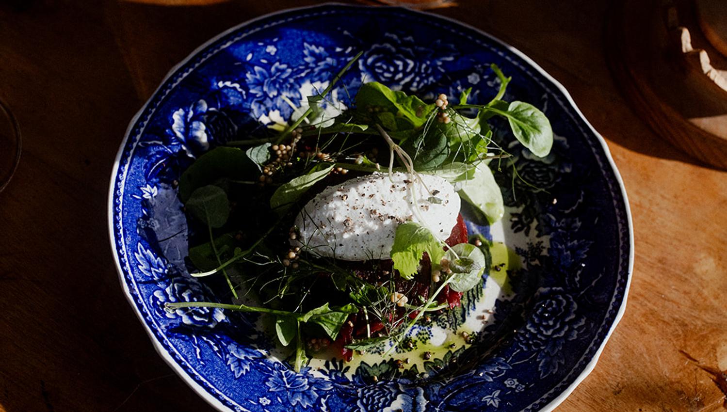 Creative dish with seasonal greens and poached egg – a flavourful dining experience at Hotel Sundal.