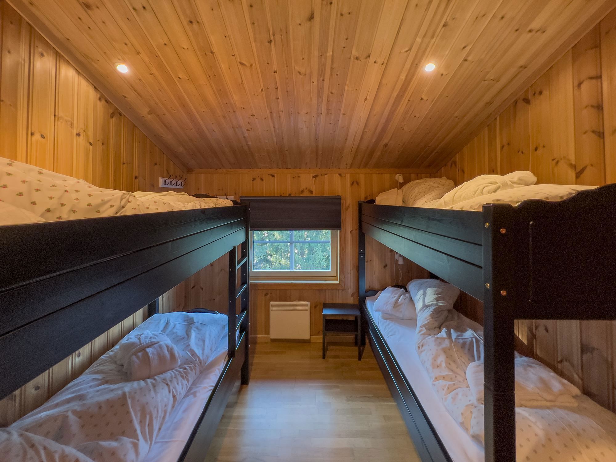 A room with bunk beds and a window.
