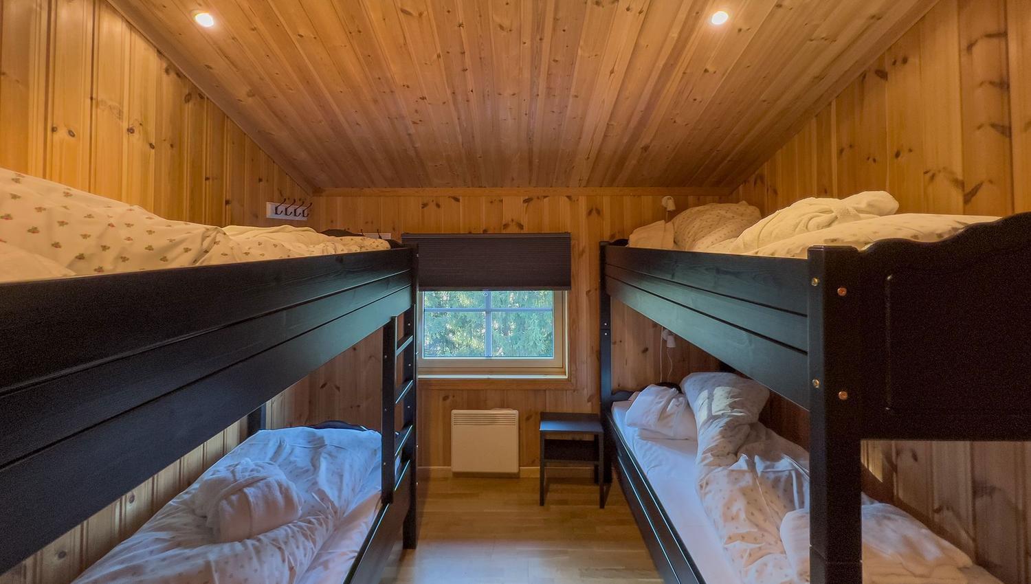 A room with bunk beds and a window.