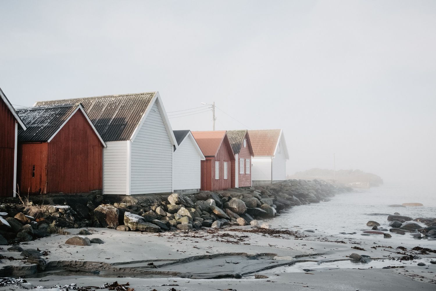The iconic sea houses at Ølberg - here fog-covered