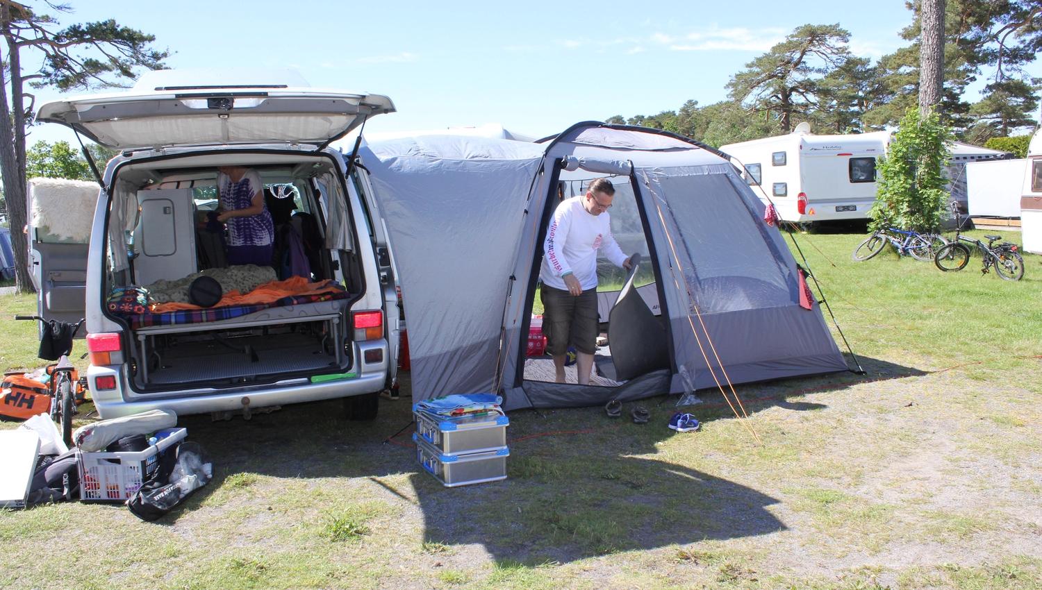 A man set up a tent next to his car