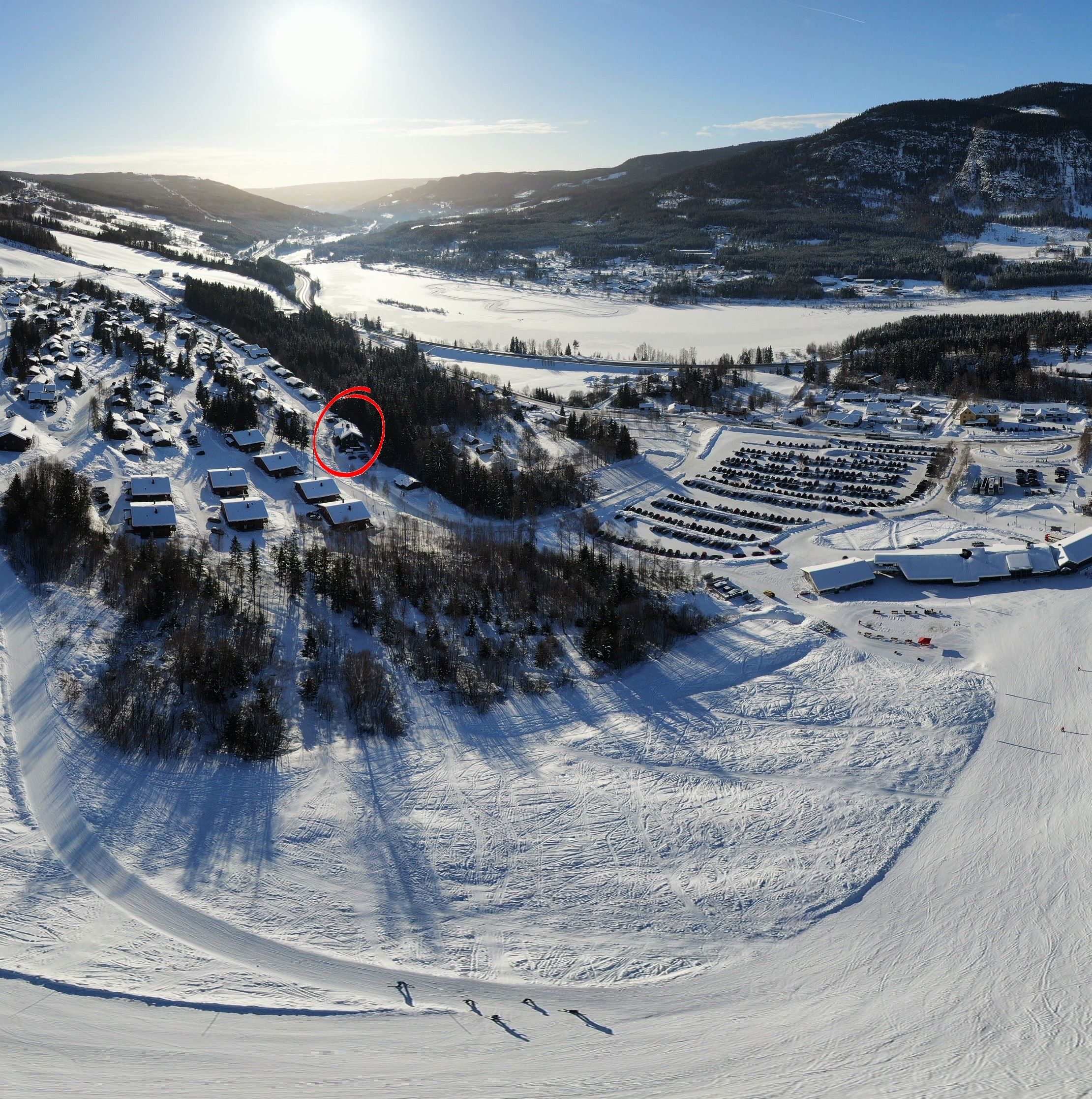 A snow-covered landscape with buildings and a river.