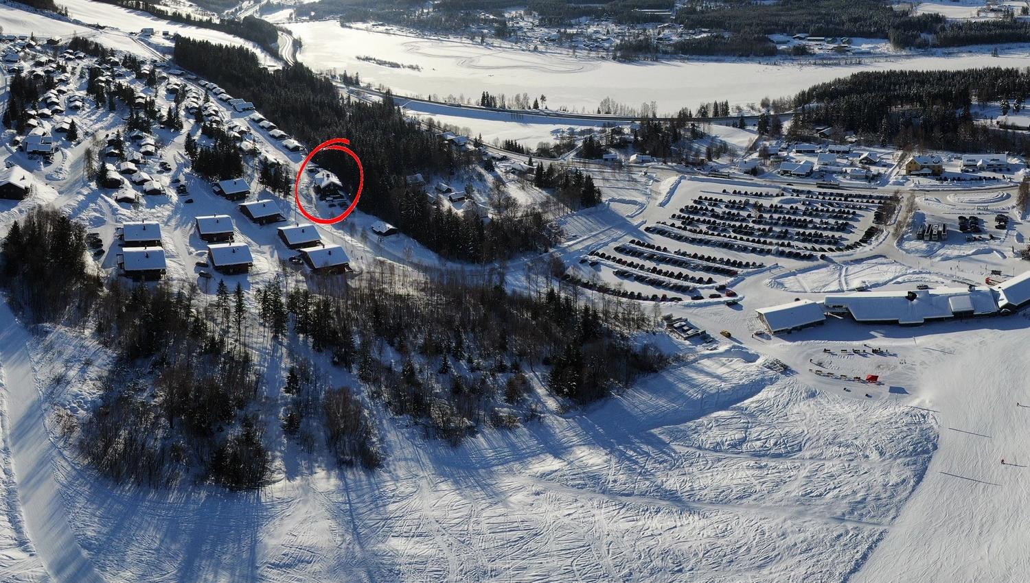 A snow-covered landscape with buildings and a river.