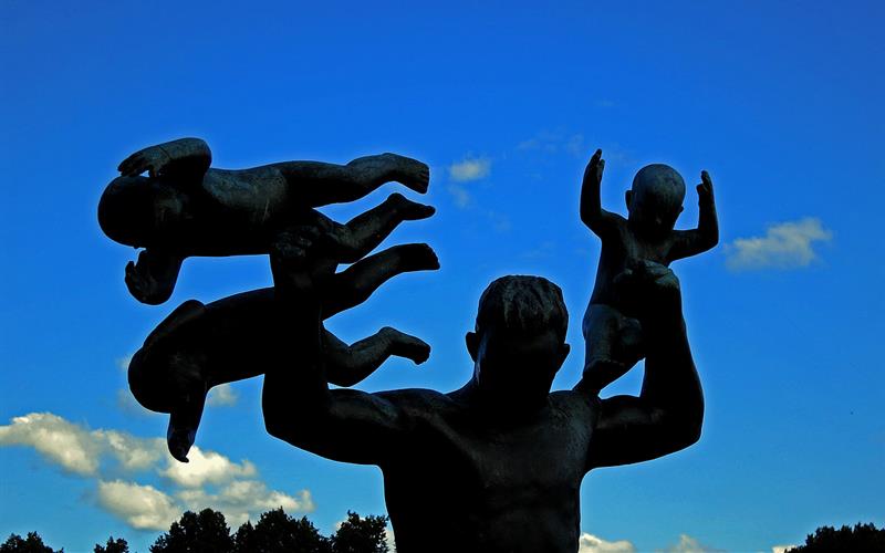 statue of an adult man with three babies
