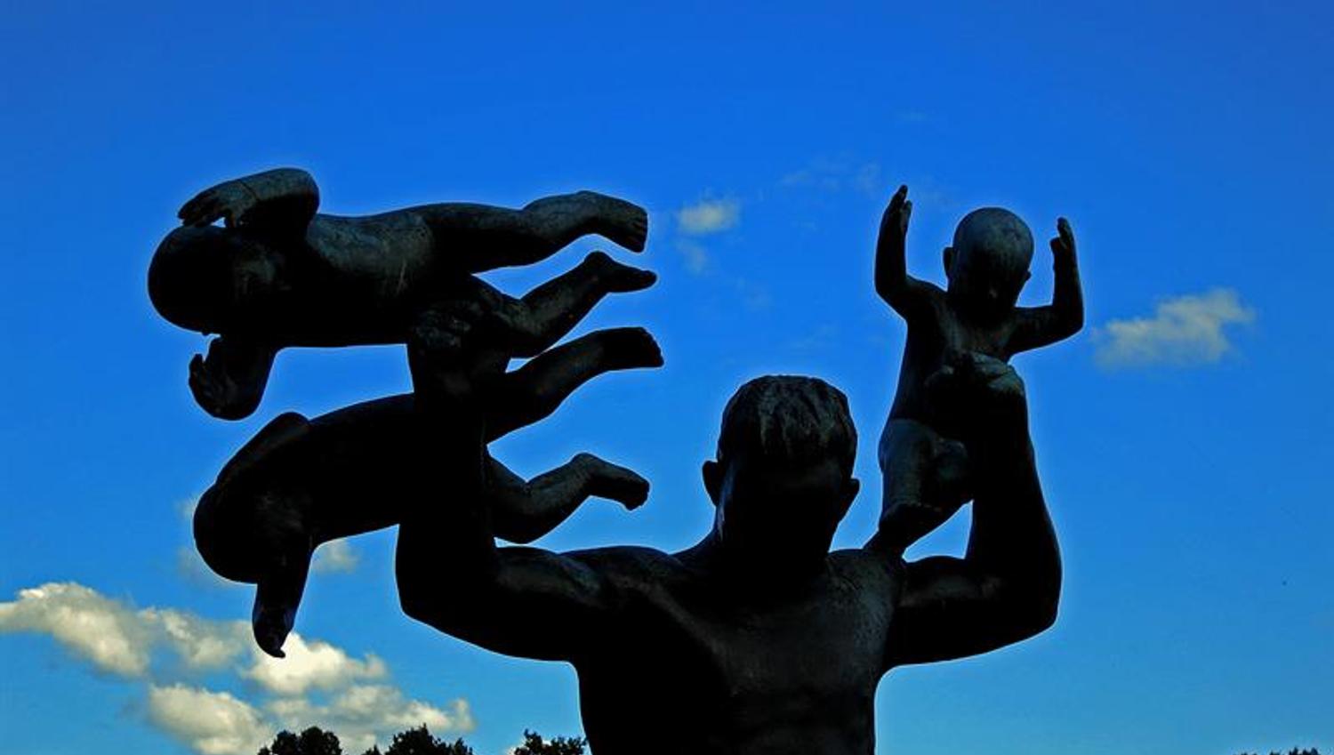 statue of an adult man with three babies