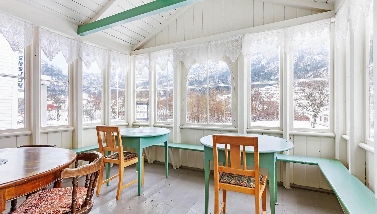 Bright conservatory with panoramic views of the Hardangerfjord from Jaunsen Guesthouse.