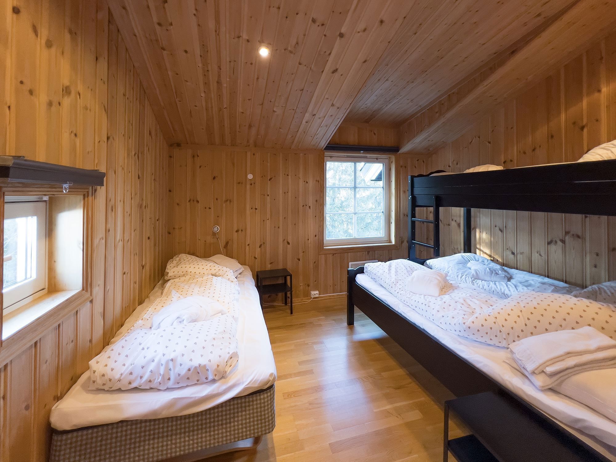 A room with bunk beds and a window.
