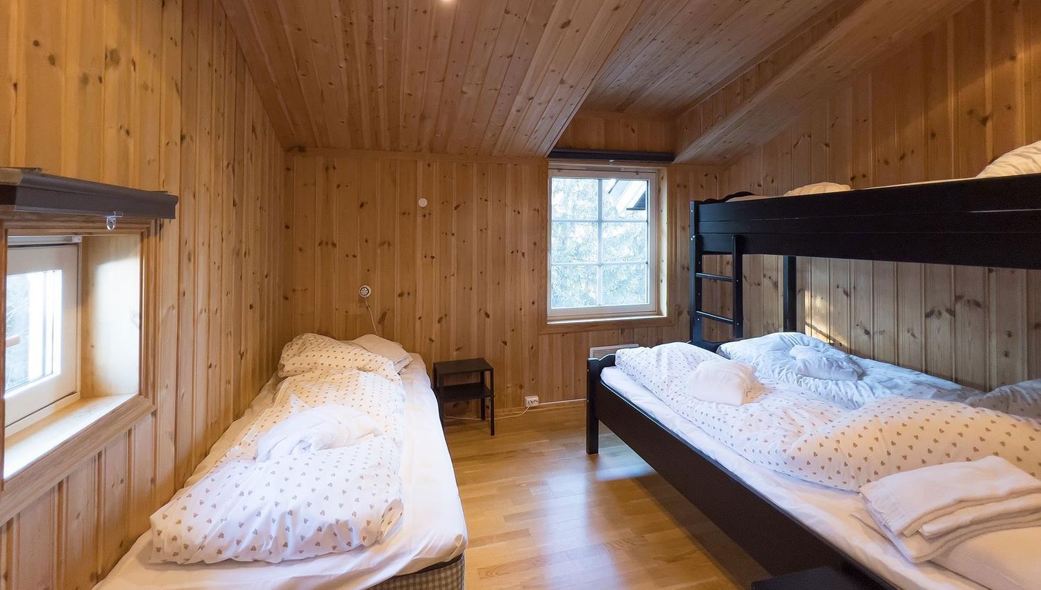 A room with bunk beds and a window.