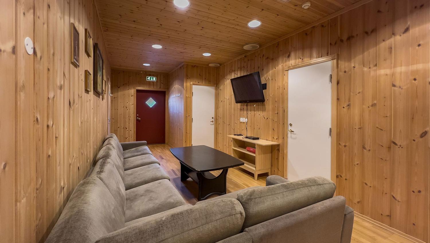 TV room with sofas and a table.