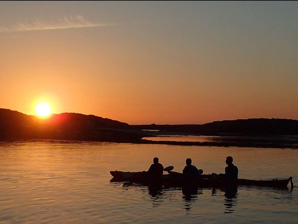 Three people on one kayak