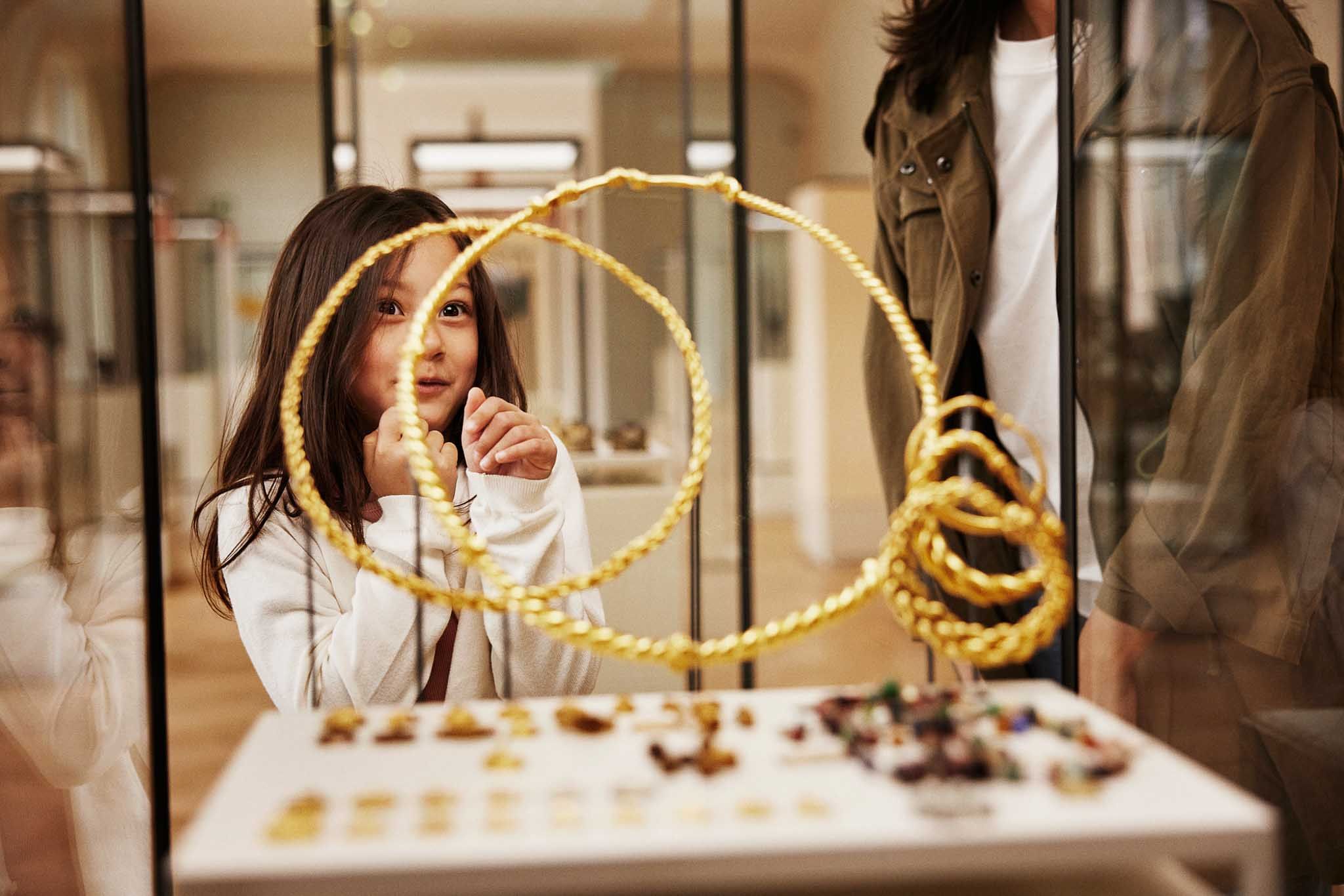 Girl looking at viking jewellery in a display case